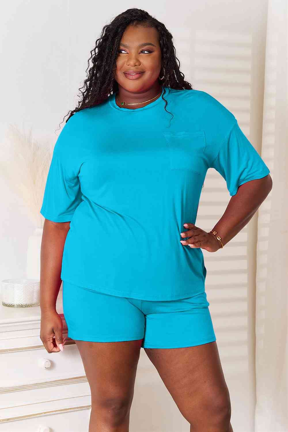Basic Bae Full Size Soft Rayon Half Sleeve Top and Shorts Set displayed on a mannequin, showcasing its relaxed fit and stylish design.