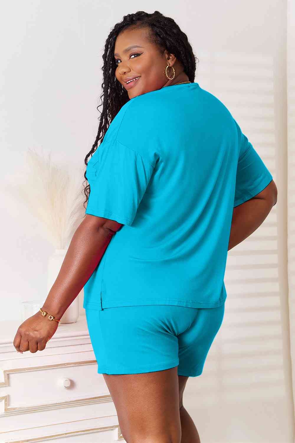 Basic Bae Full Size Soft Rayon Half Sleeve Top and Shorts Set displayed on a mannequin, showcasing its relaxed fit and stylish design.