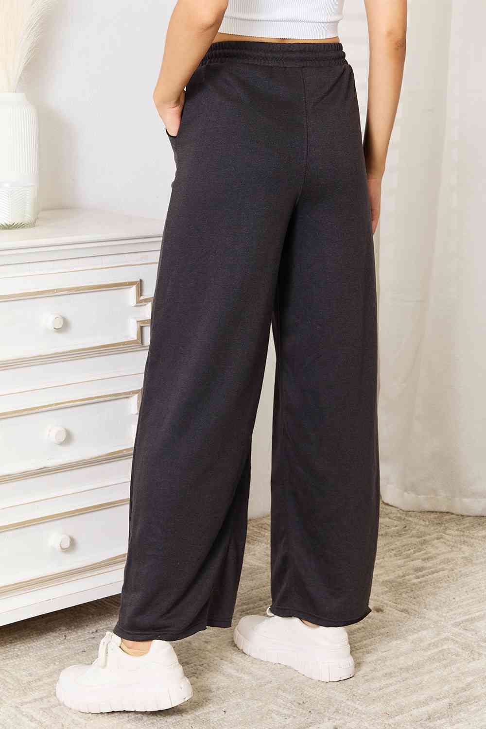 Basic Bae Wide Leg Pocketed Pants in a stylish design with pockets, showcasing a relaxed fit and trendy silhouette.