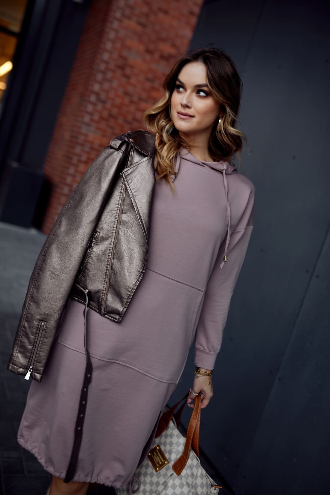 Cappuccino basic dress with a hood, pocket, and ties, showcasing long sleeves and a stylish design.