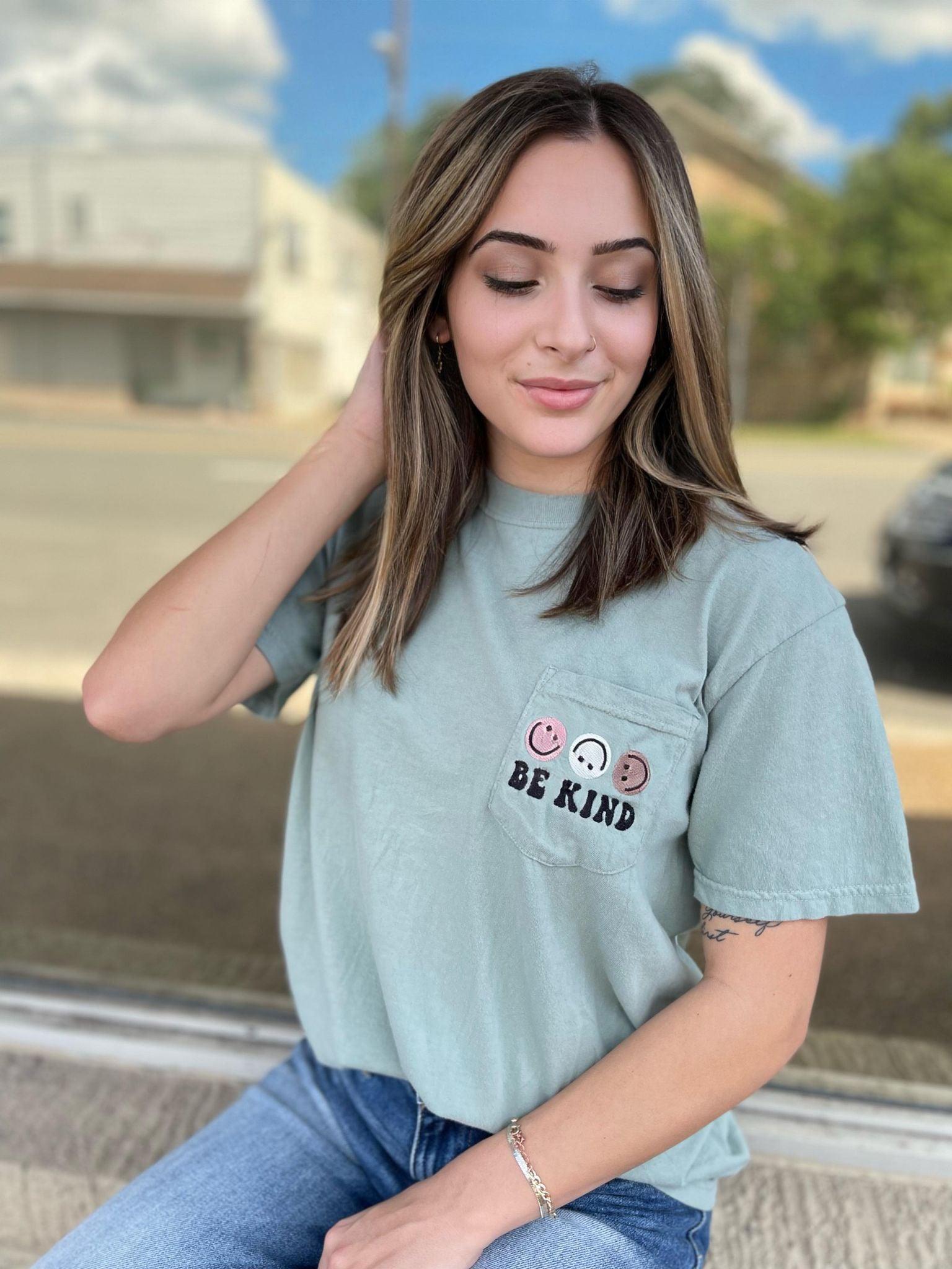 Be Kind Smiley Embroidered T-Shirt in Bay color featuring a cute smiley graphic on the pocket.