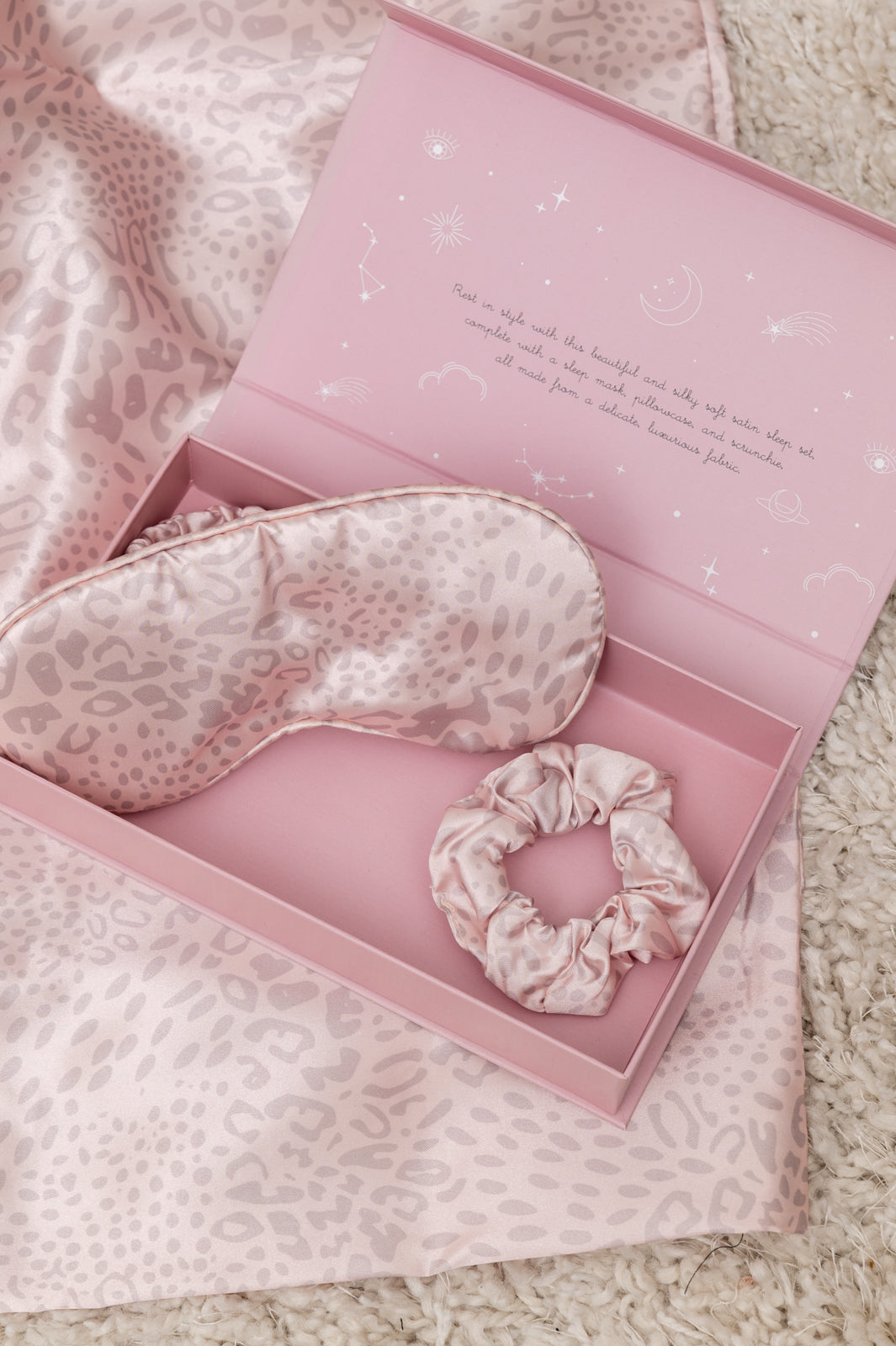 Beauty Reset Three Piece Satin Sleep Set including a pink satin pillowcase, sleep mask, and hair scrunchie, designed for luxurious sleep.