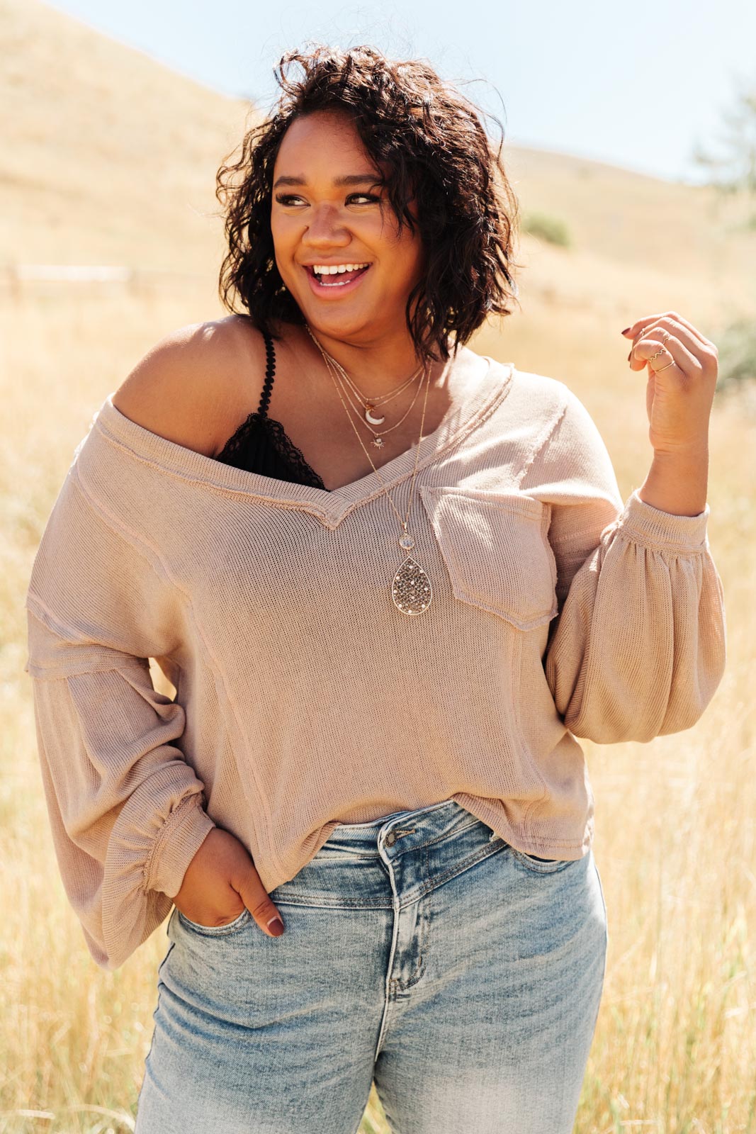 Bellissimo Draped V-Neck Sweater in Mocha, showcasing its deep V-neckline and raw stitching details.