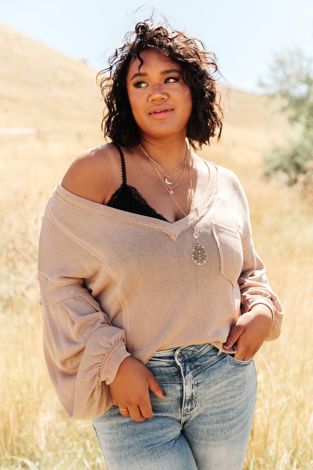 Bellissimo Draped V-Neck Sweater in Mocha, showcasing its deep V-neckline and raw stitching details.