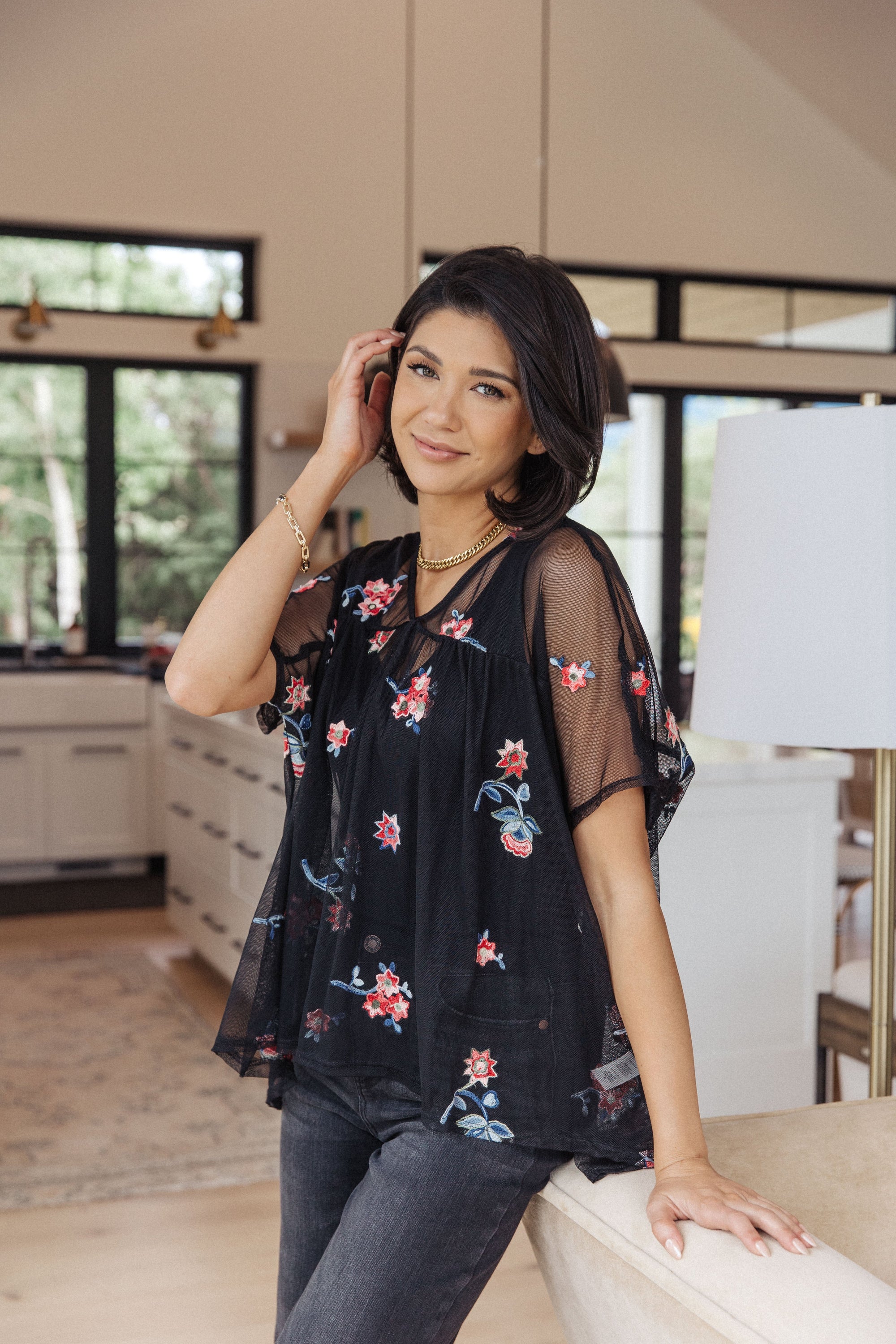 A stylish Best We've Got Embroidered Blouse featuring delicate floral embroidery on soft mesh, with dolman sleeves and a v-neckline.