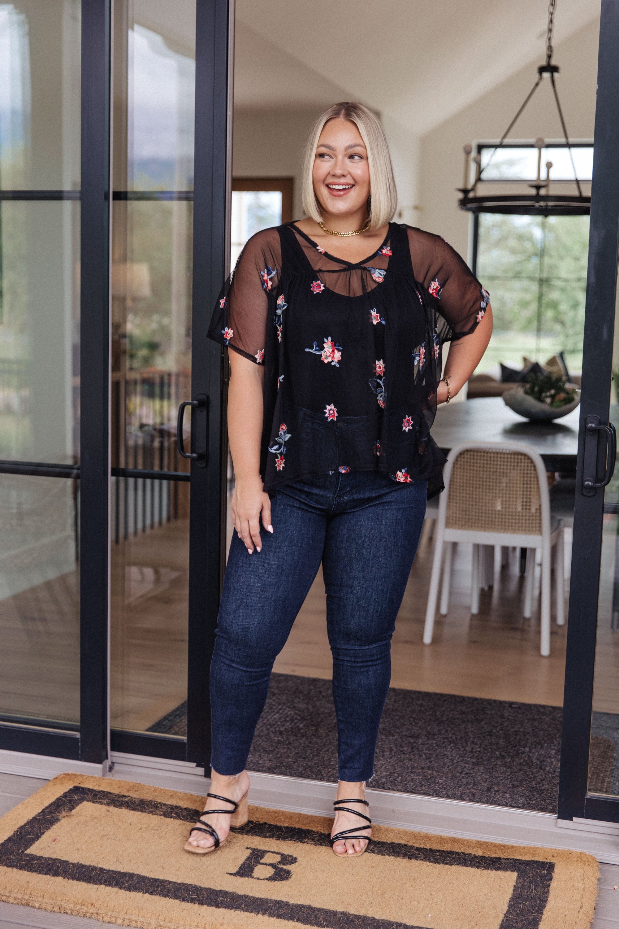 A stylish Best We've Got Embroidered Blouse featuring delicate floral embroidery on soft mesh, with dolman sleeves and a v-neckline.