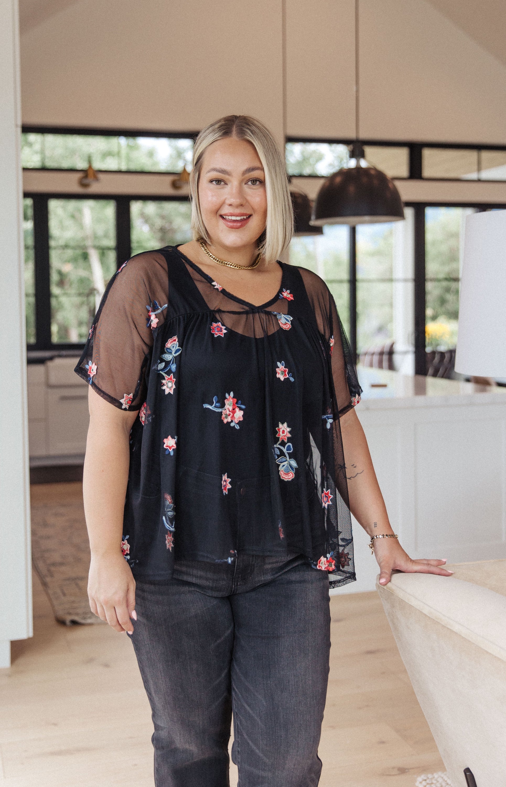 A stylish Best We've Got Embroidered Blouse featuring delicate floral embroidery on soft mesh, with dolman sleeves and a v-neckline.