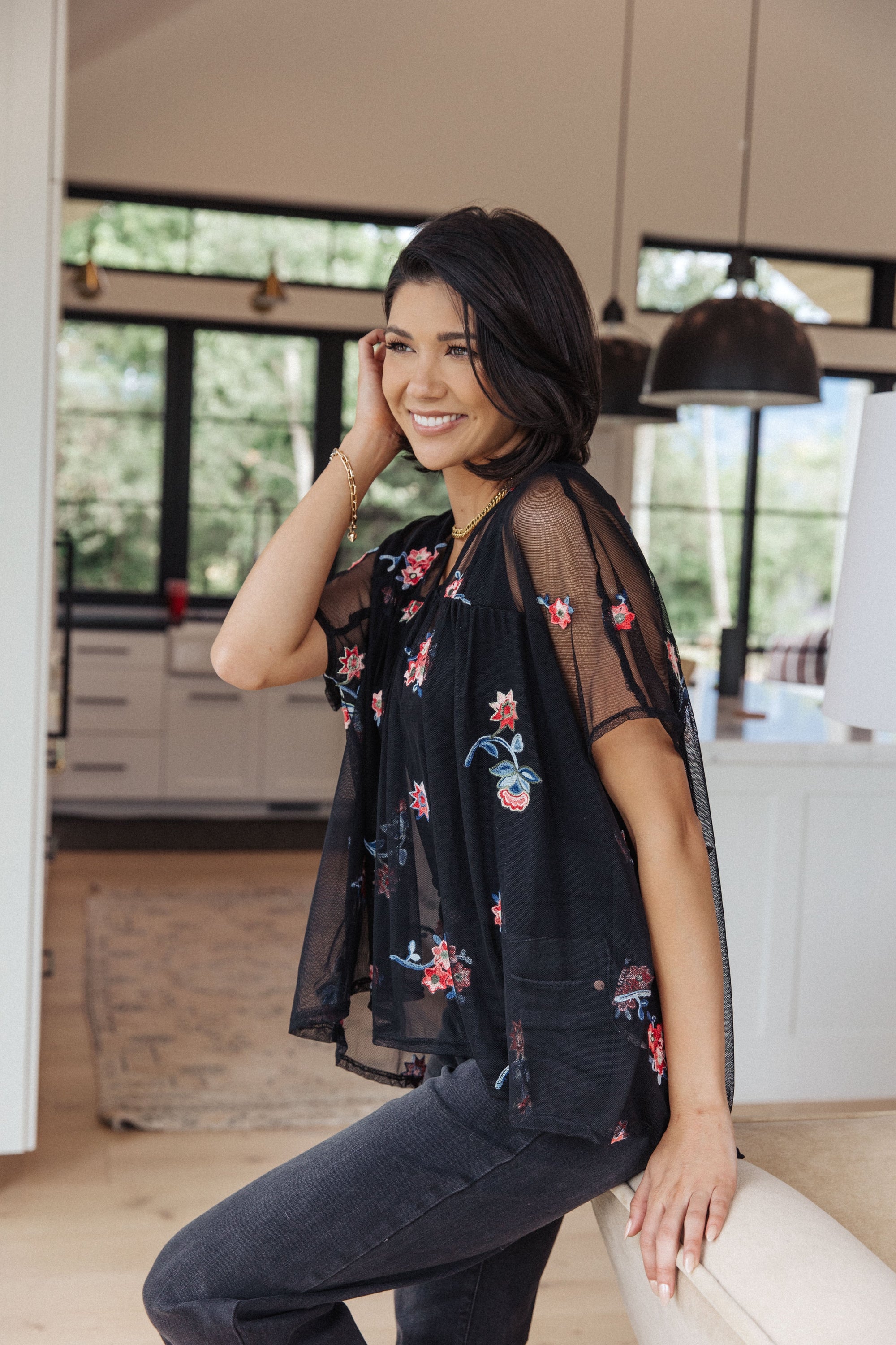 A stylish Best We've Got Embroidered Blouse featuring delicate floral embroidery on soft mesh, with dolman sleeves and a v-neckline.