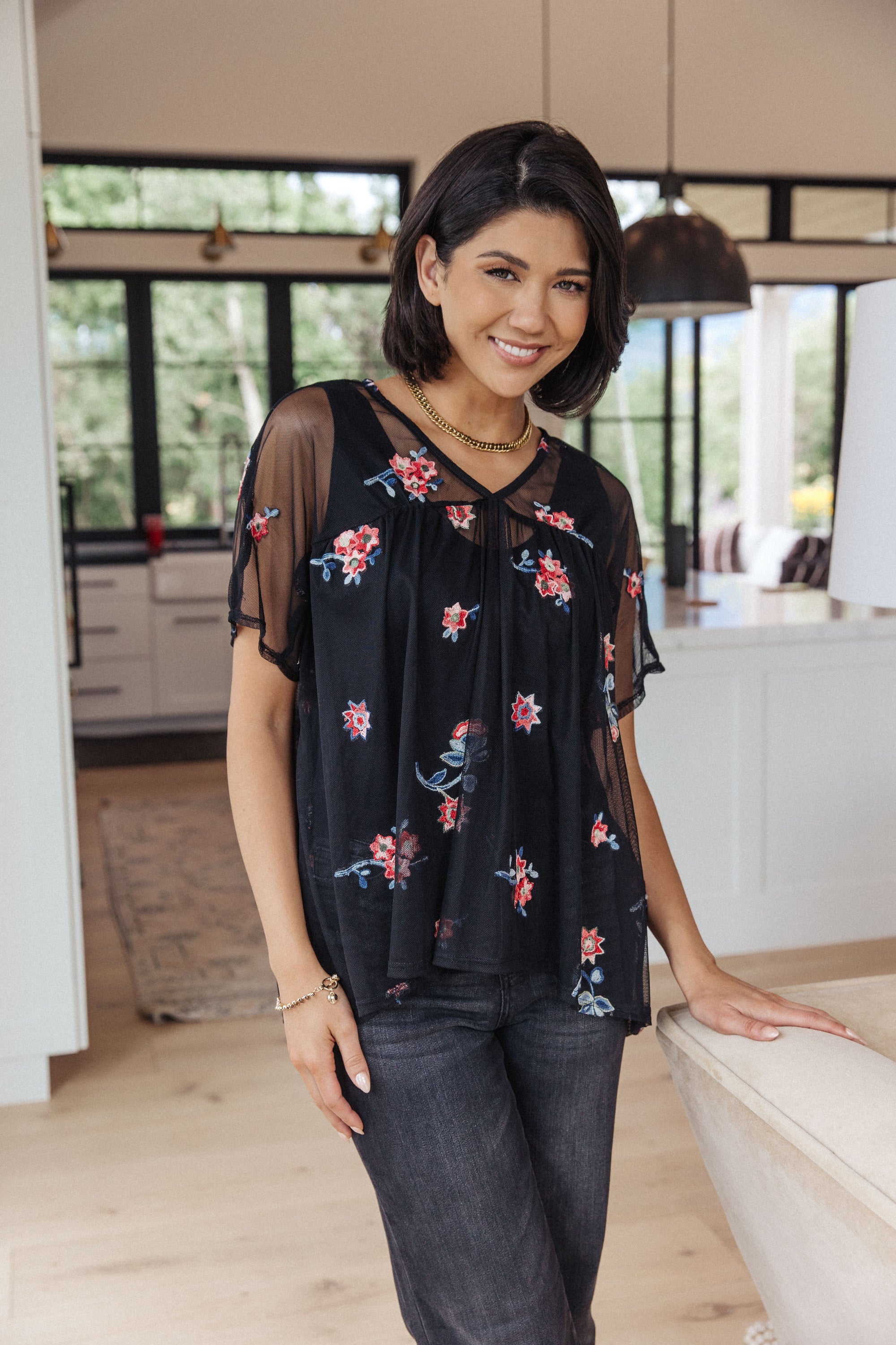 A stylish Best We've Got Embroidered Blouse featuring delicate floral embroidery on soft mesh, with dolman sleeves and a v-neckline.