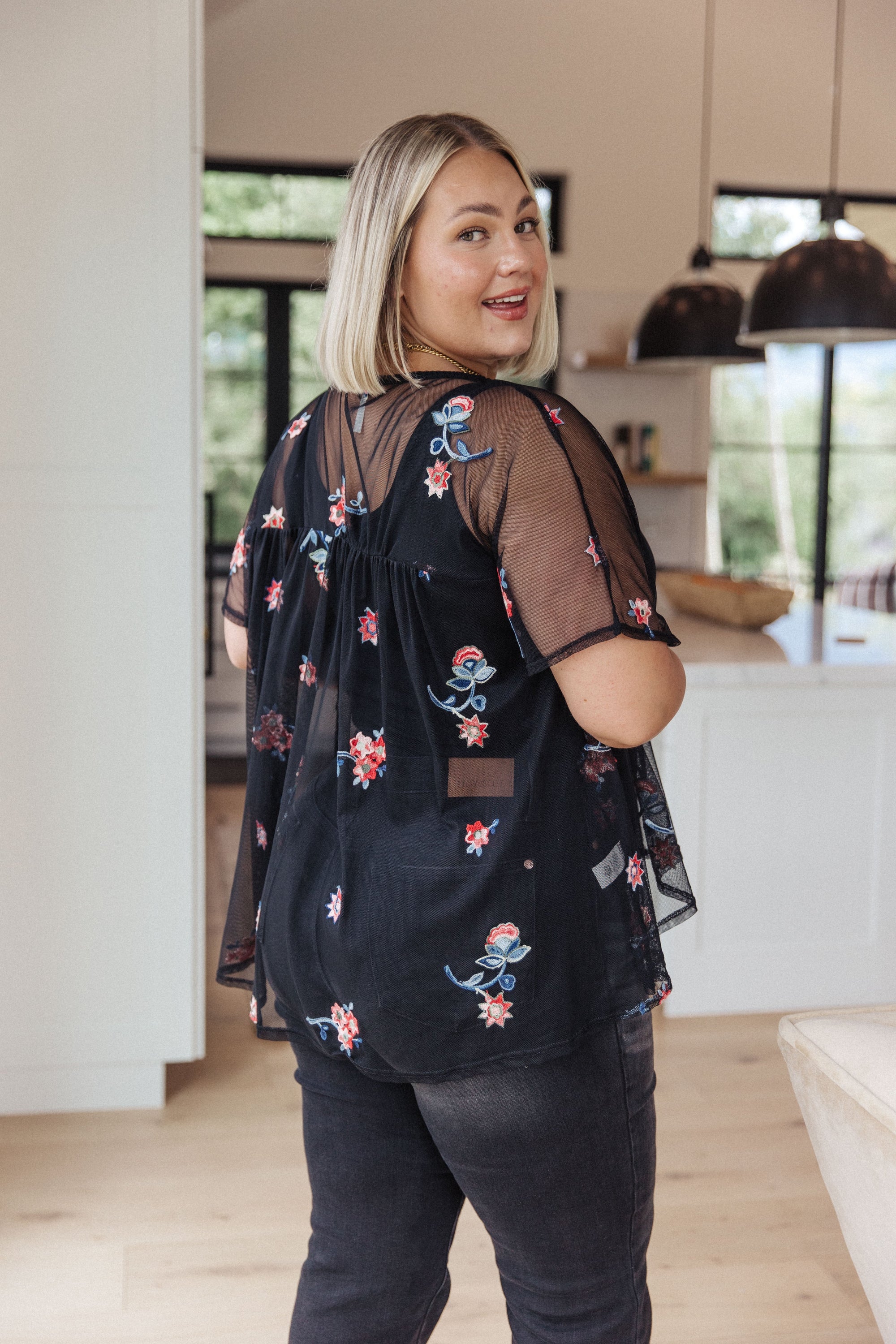 A stylish Best We've Got Embroidered Blouse featuring delicate floral embroidery on soft mesh, with dolman sleeves and a v-neckline.