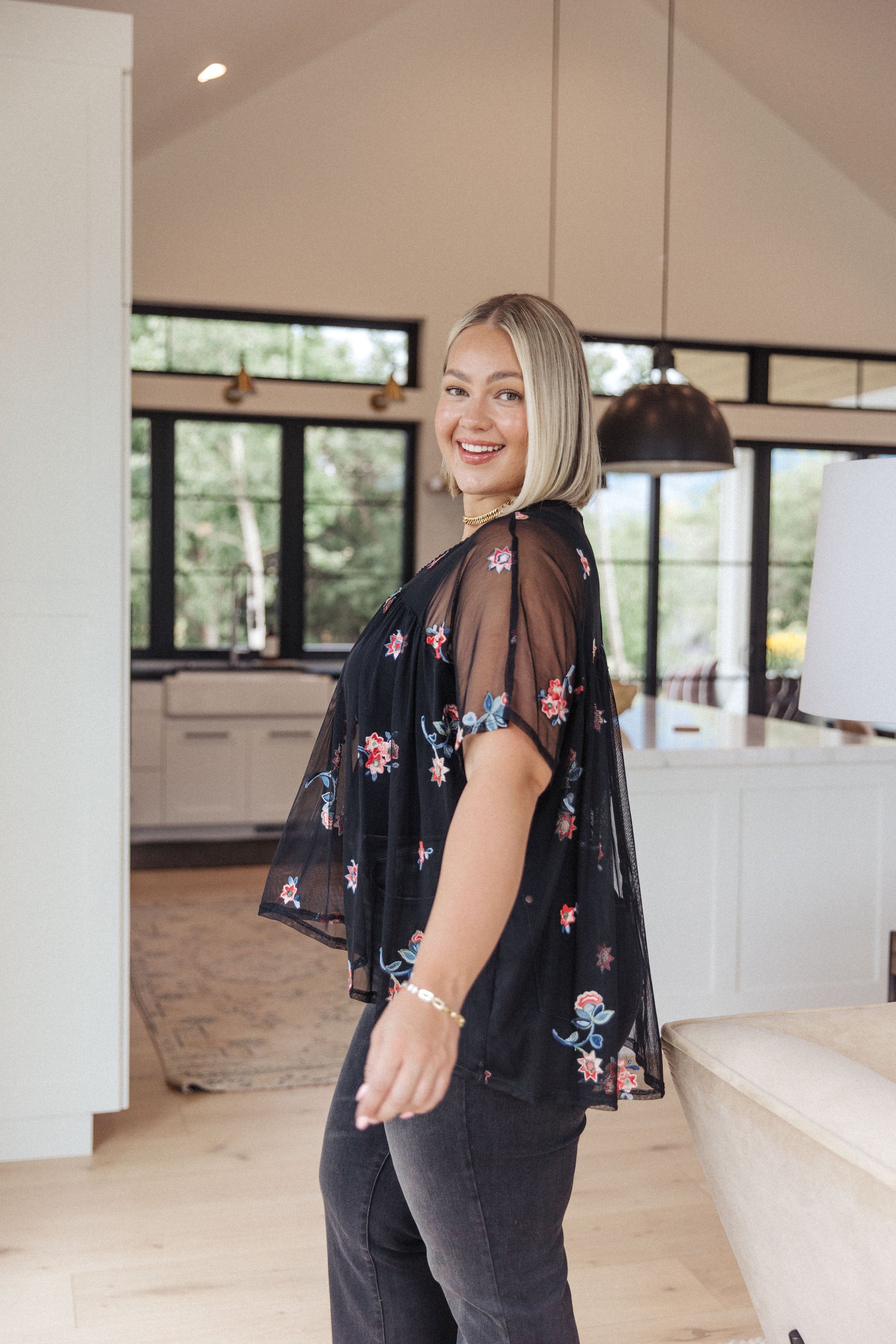 A stylish Best We've Got Embroidered Blouse featuring delicate floral embroidery on soft mesh, with dolman sleeves and a v-neckline.