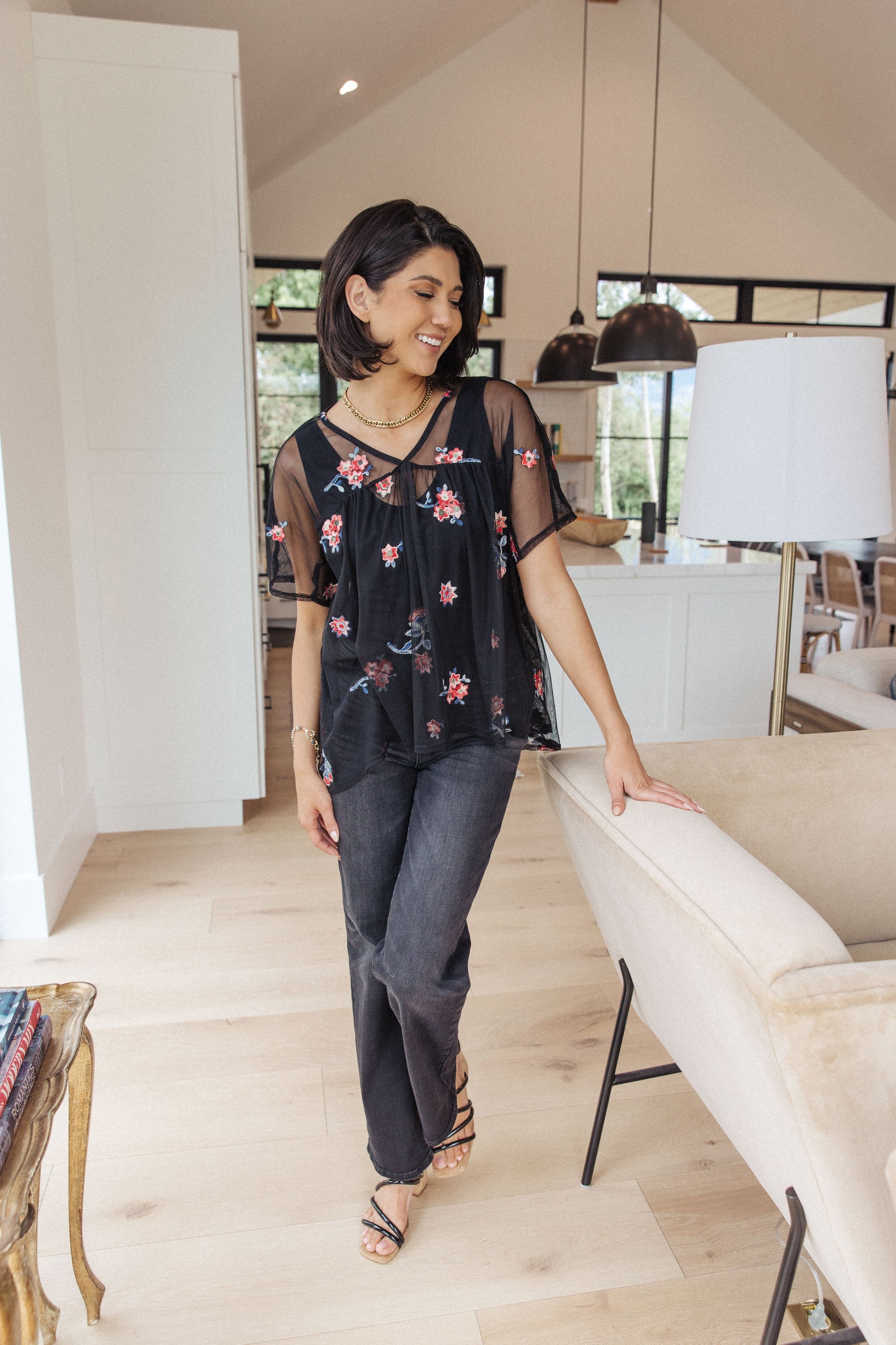 A stylish Best We've Got Embroidered Blouse featuring delicate floral embroidery on soft mesh, with dolman sleeves and a v-neckline.