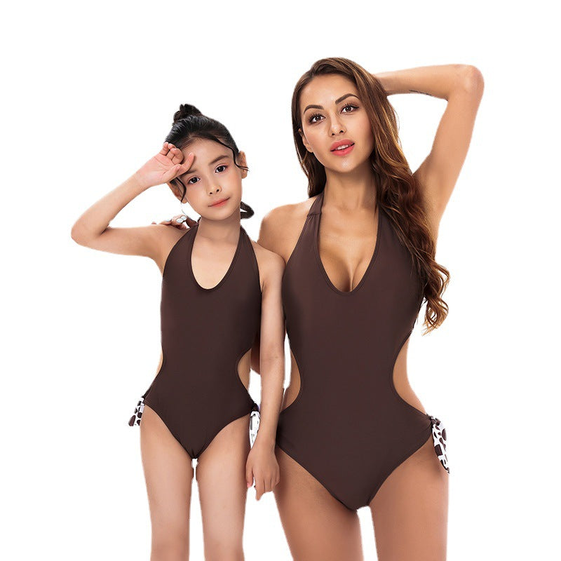 A stylish solid color one-piece parent-child swimsuit bikini, showcasing its sleek design and high-quality fabric.