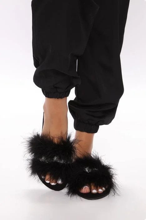 Stylish black feather flat slide sandals with a comfortable design, perfect for summer wear.