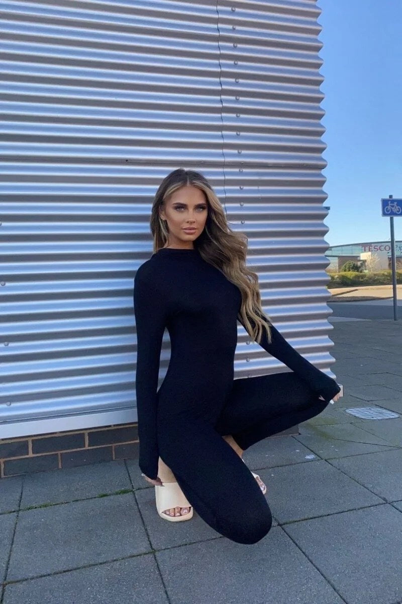 A stylish black high neck long sleeve jumpsuit displayed on a mannequin, showcasing its elegant design and flattering silhouette.