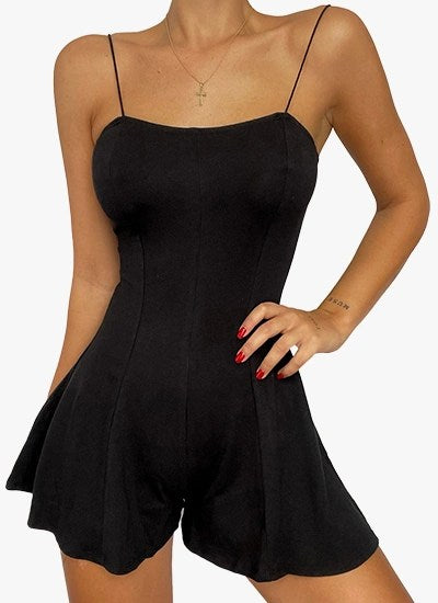 A stylish black romper featuring thin bungee straps and flowy shorts, perfect for casual and dressy occasions.