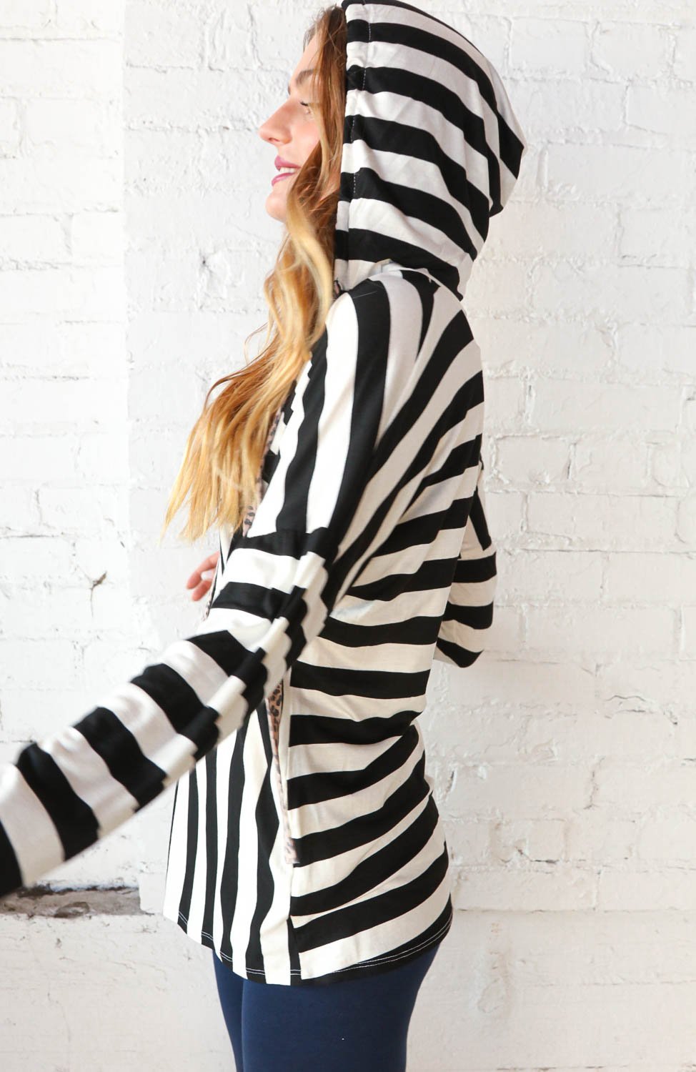 Black and white striped hoodie with leopard print drawstrings, showcasing a stylish V-neck design.
