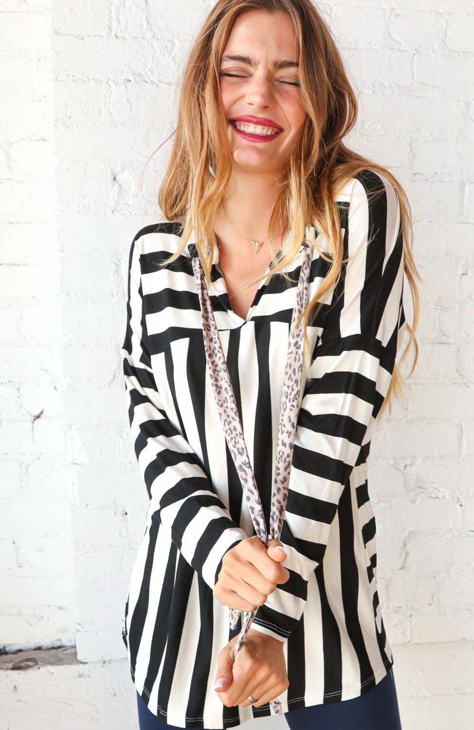 Black and white striped hoodie with leopard print drawstrings, showcasing a stylish V-neck design.
