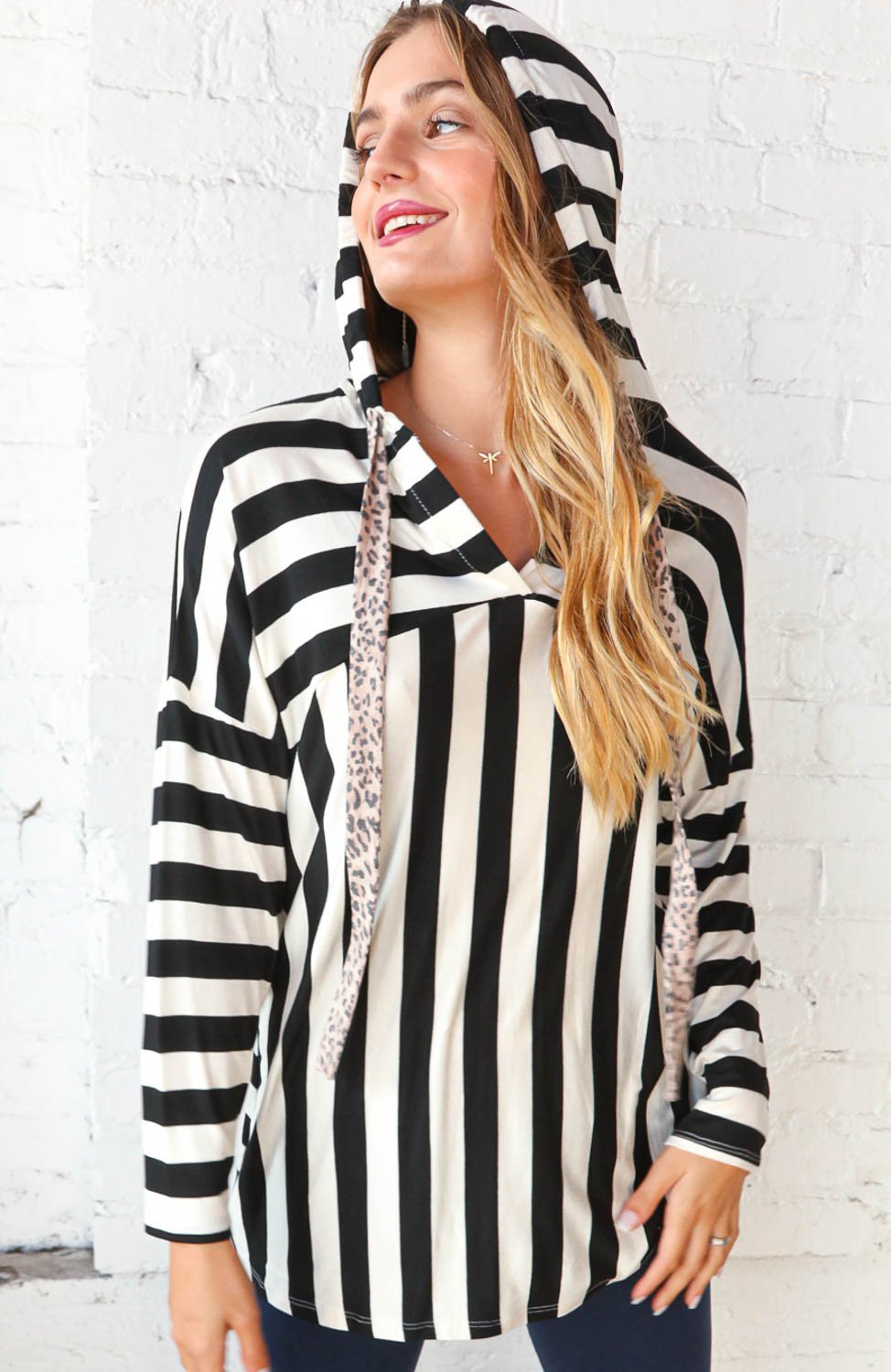 Black and white striped hoodie with leopard print drawstrings, showcasing a stylish V-neck design.