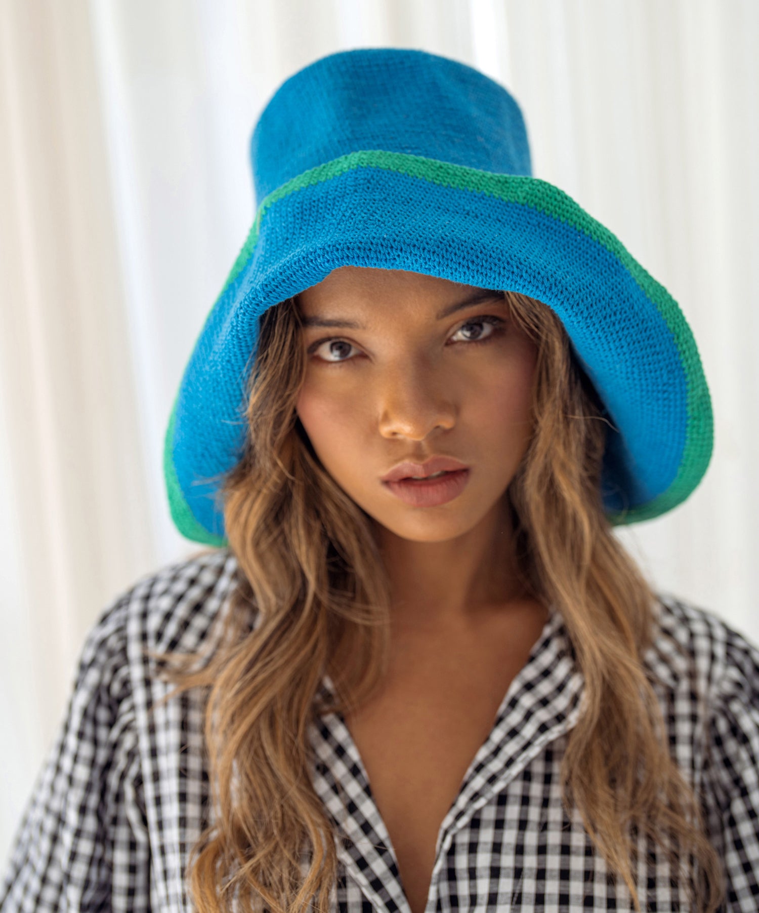 BLOOM LINE Crochet Sun Hat in Mosaic Blue, showcasing its unique Calla Lily flower shape and soft crochet texture.