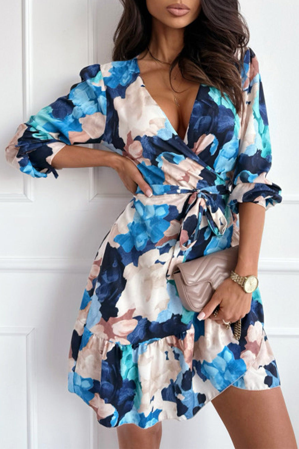 A stylish blue abstract floral long sleeve dress featuring a tied sash, puff sleeves, and a ruffled hemline, perfect for various occasions.