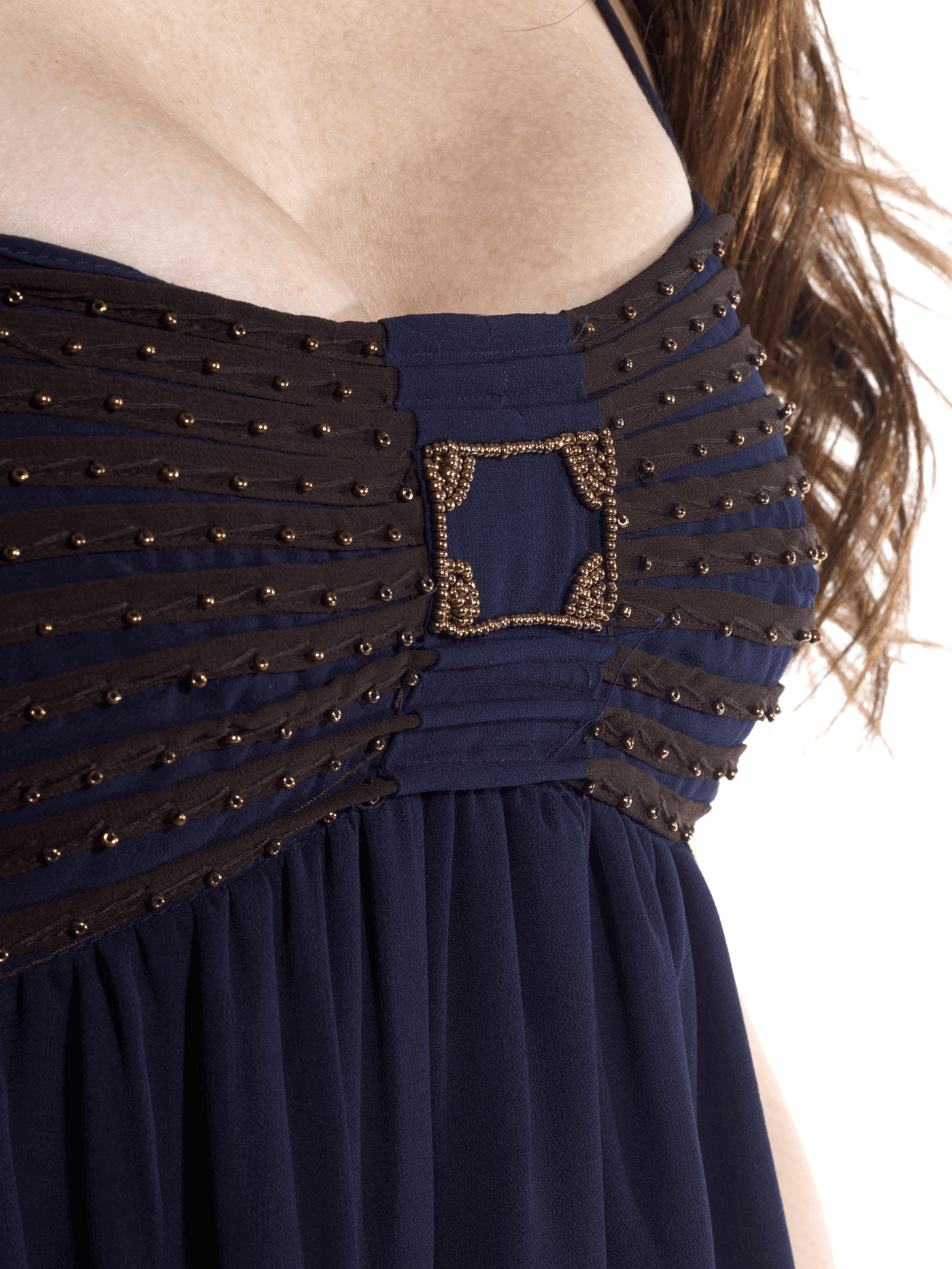 A beautiful blue flowy dress adorned with gold embellishments, featuring a low cut hem for a stylish look.