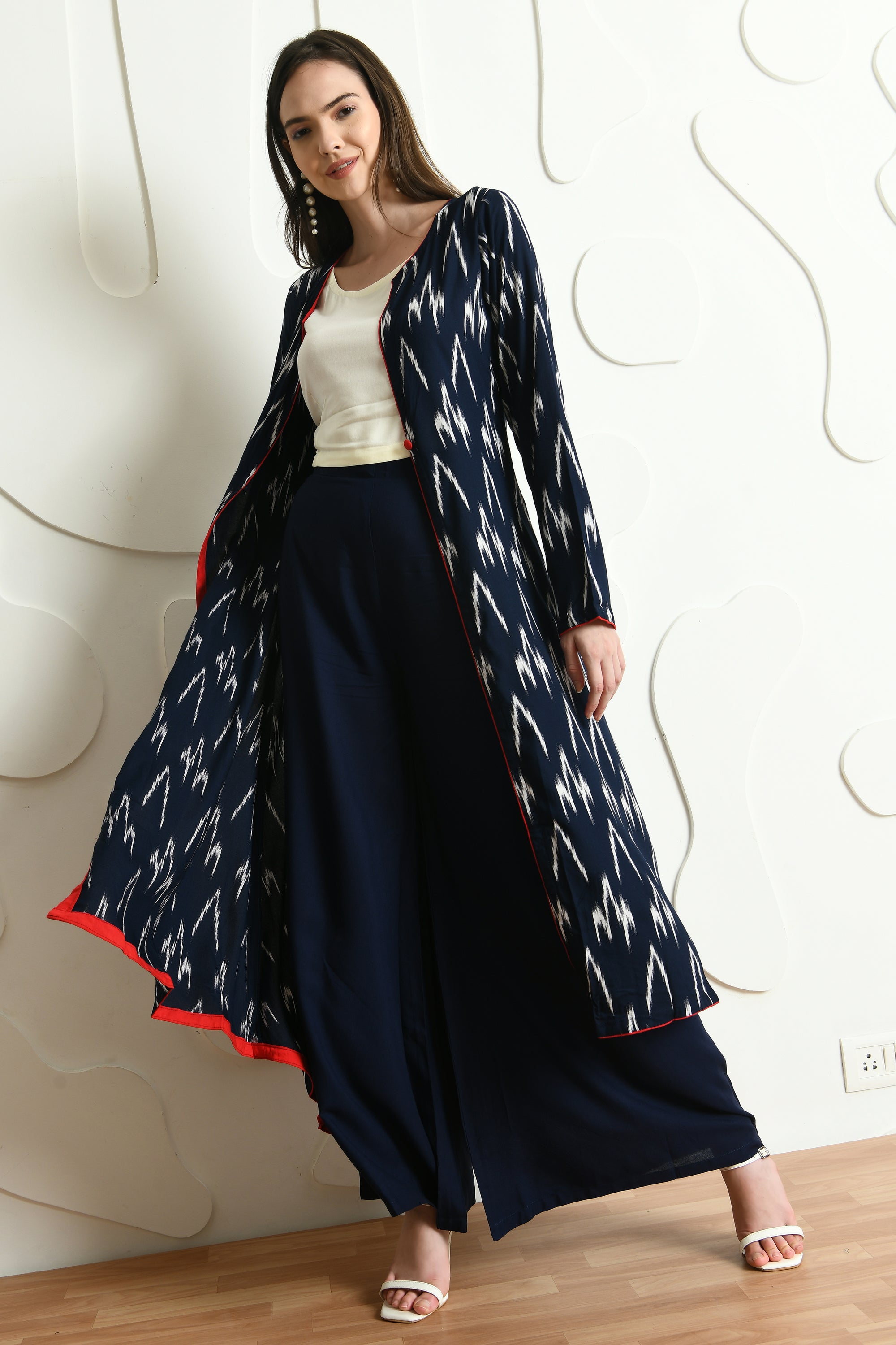 A stylish Blue Ikhat Print Three PC set featuring a full sleeve jacket, sleeveless crop top, and palazzo bottoms, perfect for semi-formal occasions.