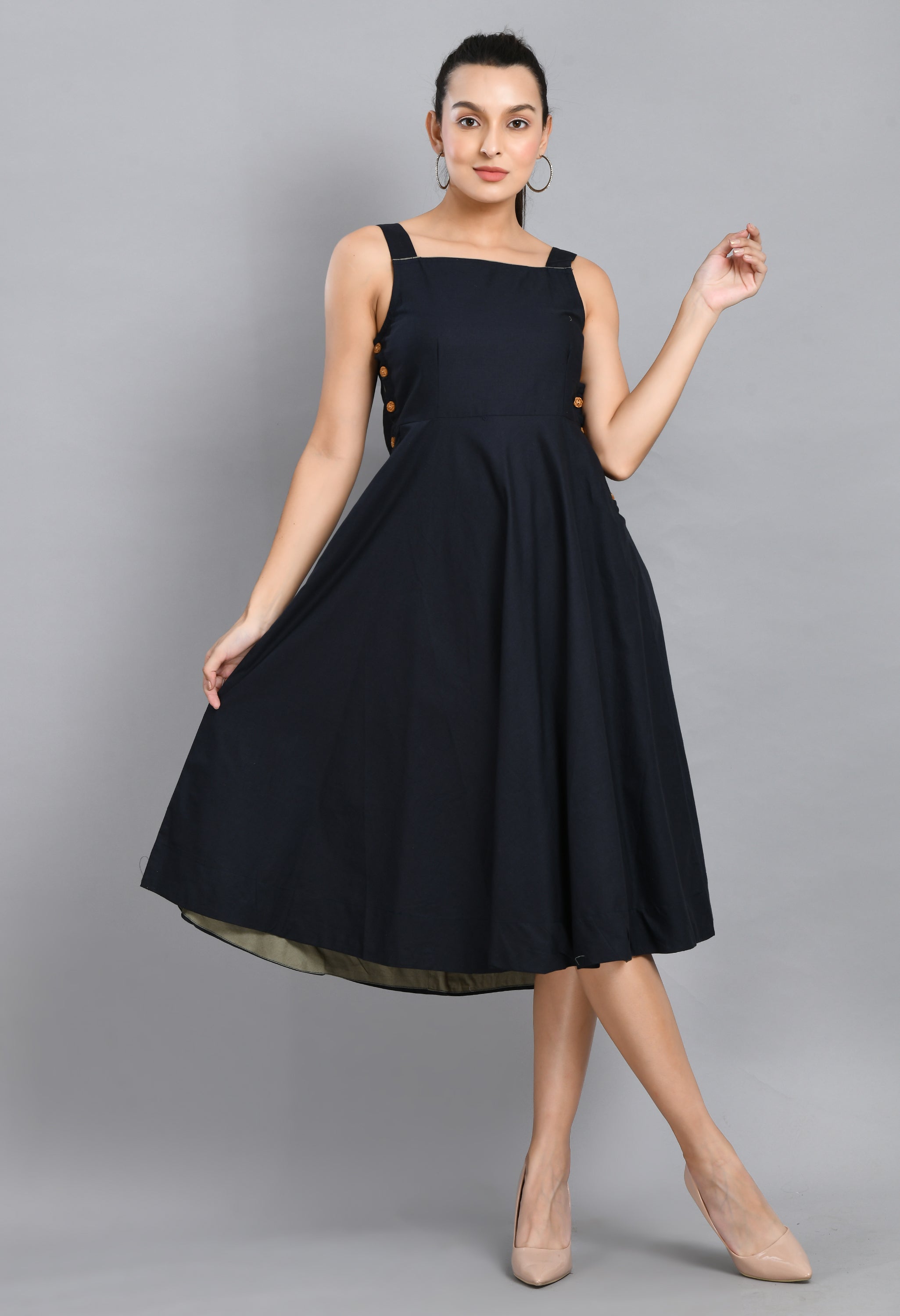 A stylish blue linen sleeveless dress with wood buttons and an asymmetrical hem, perfect for casual wear.