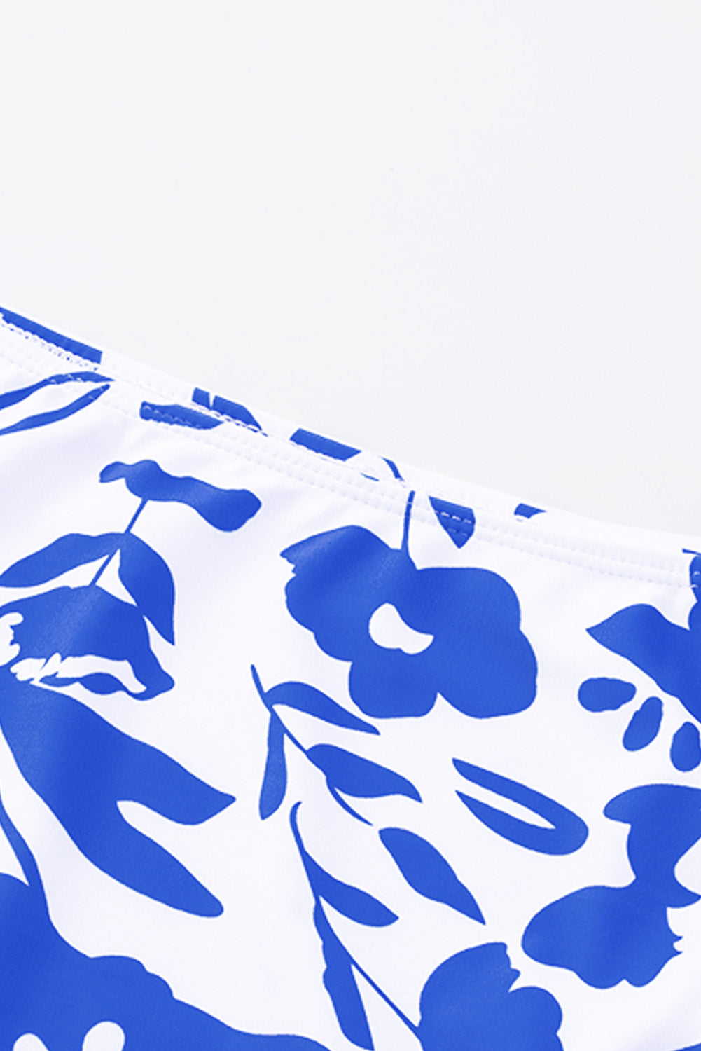 Blue square neck sleeveless tankini set featuring a stylish print and front snap button closure, perfect for beach outings.