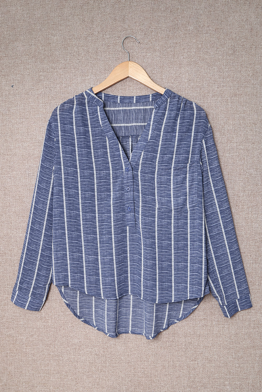 A stylish blue striped long sleeve blouse featuring a v-neckline and pockets, perfect for casual and formal occasions.