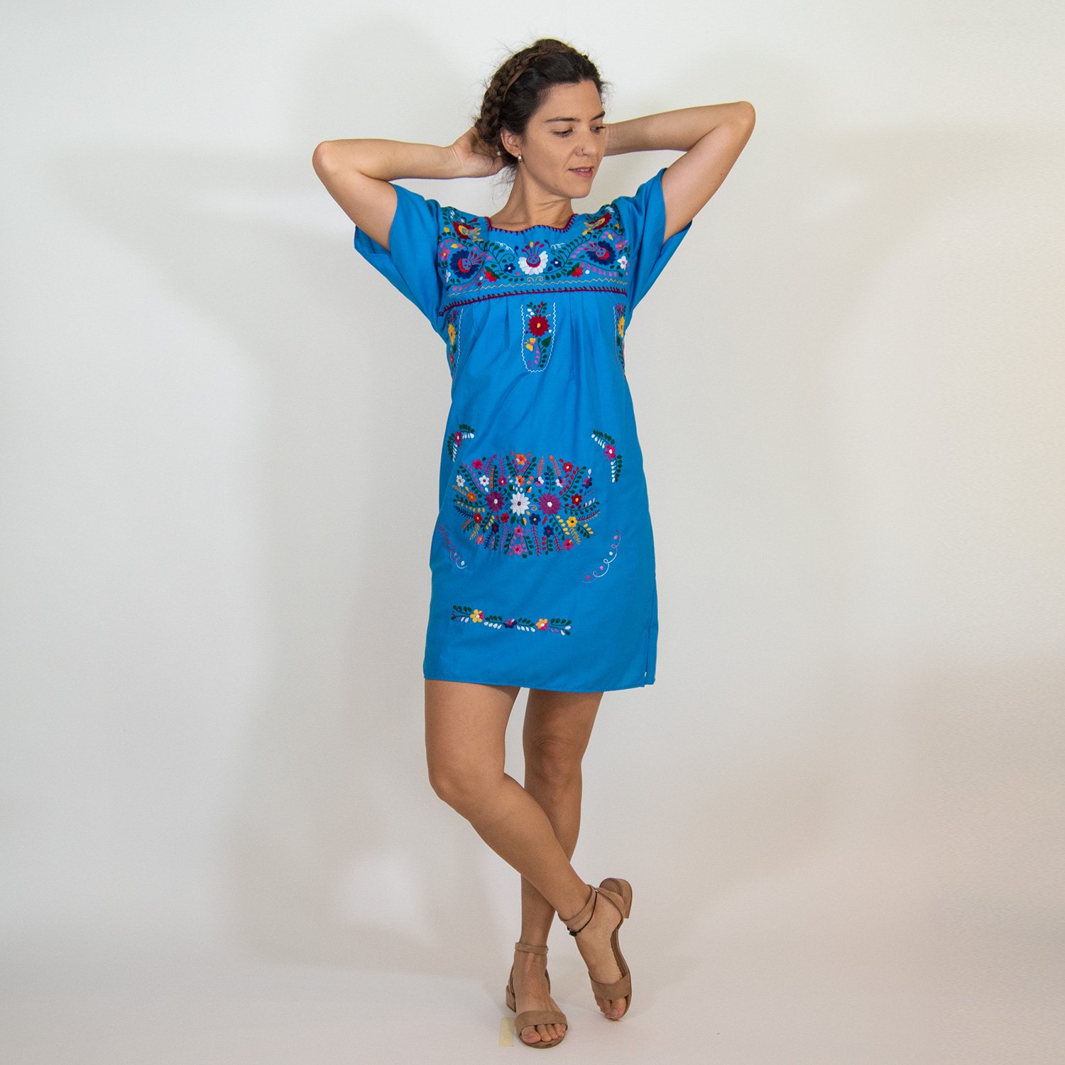 A beautiful blue vintage dress featuring hand-embroidered flowers, showcasing intricate designs and vibrant colors, perfect for various occasions.
