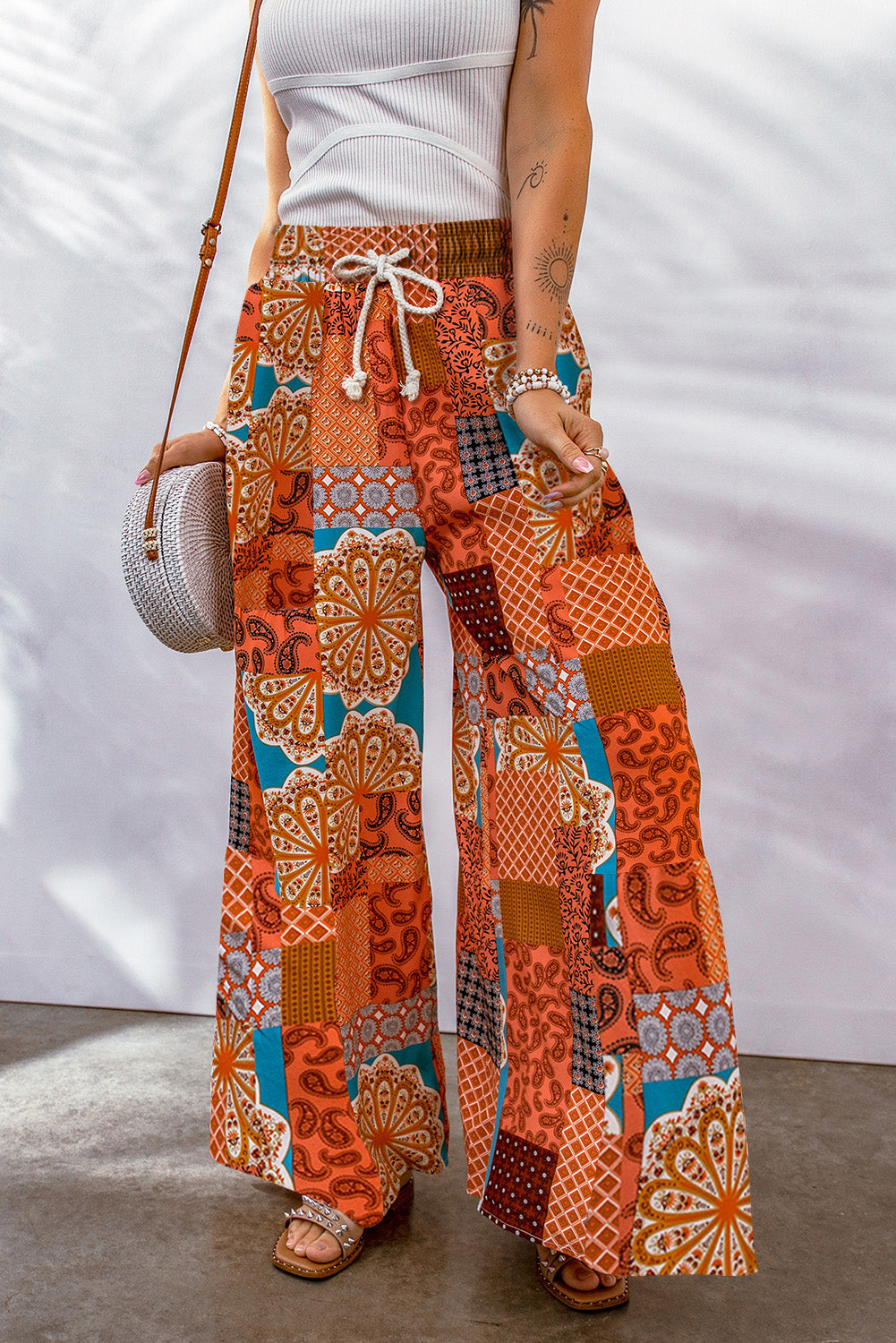A pair of stylish Boho Drawstring Wide Leg Pants featuring a colorful patchwork design, perfect for casual and holiday wear.