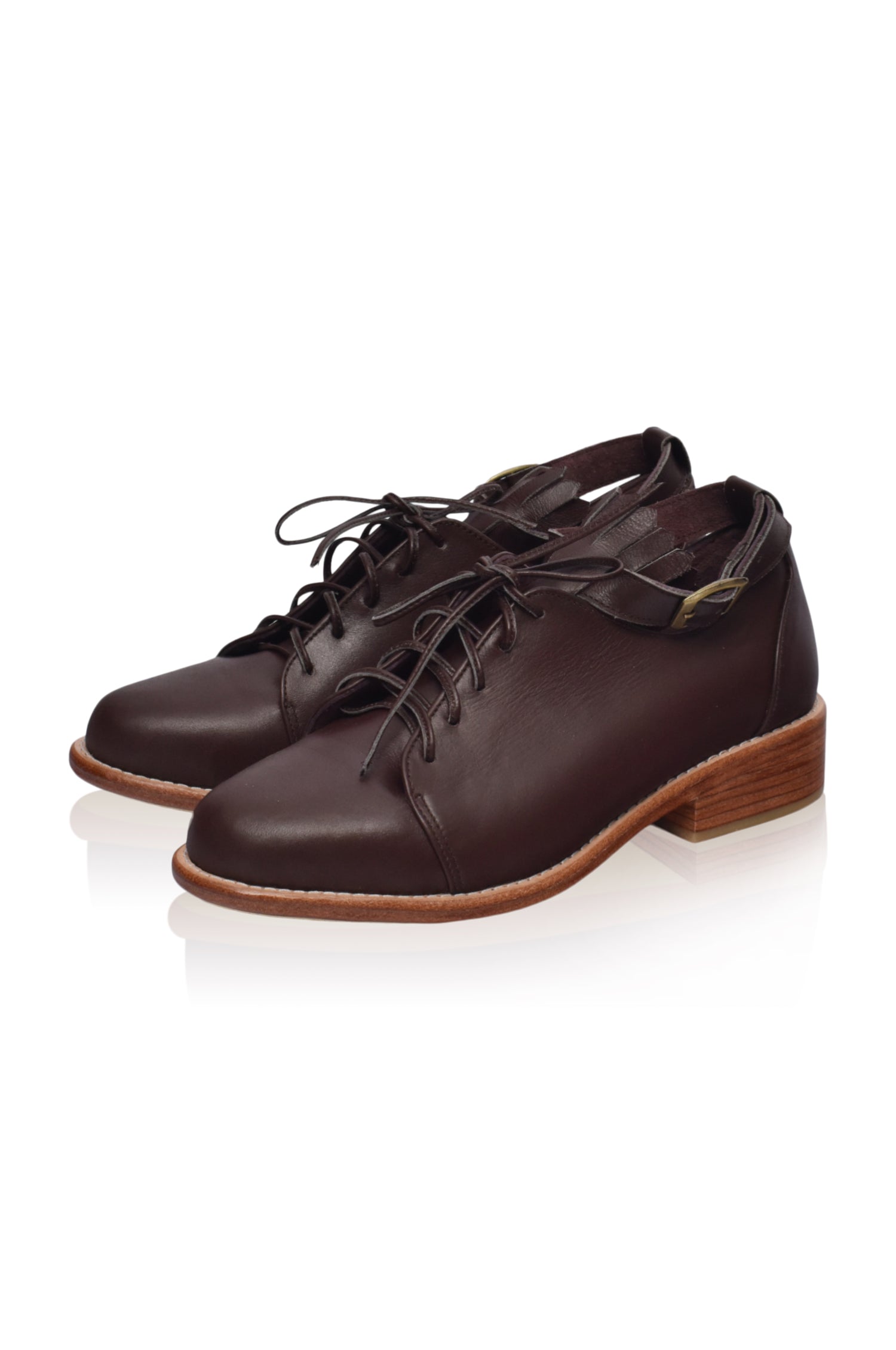 A pair of stylish Boston Leather Oxfords featuring fringe detailing and an ankle strap, showcasing their elegant design and genuine leather material.