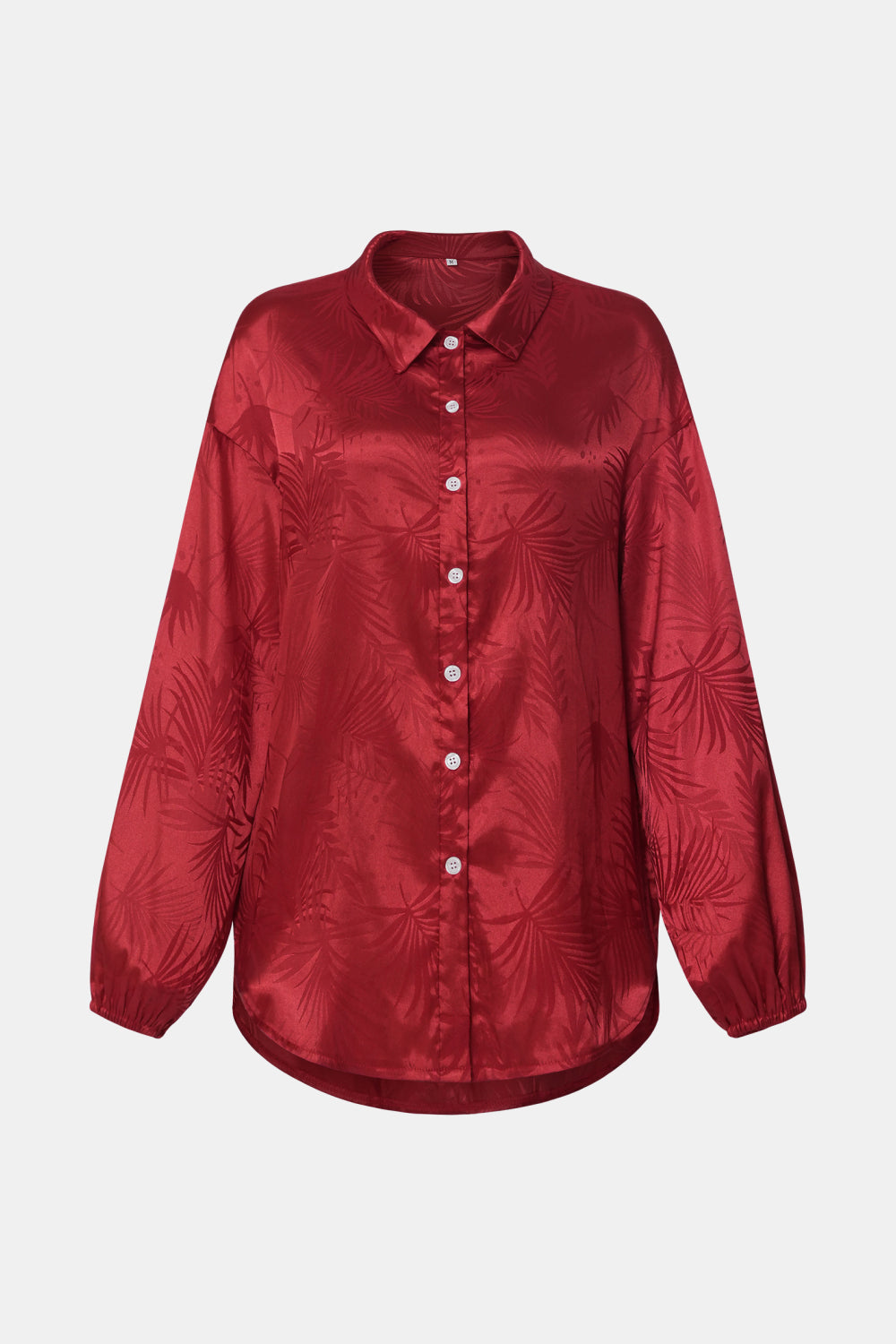 A stylish botanical print collared shirt with dropped shoulders, featuring a curved hem and long sleeves, displayed in multiple color options.