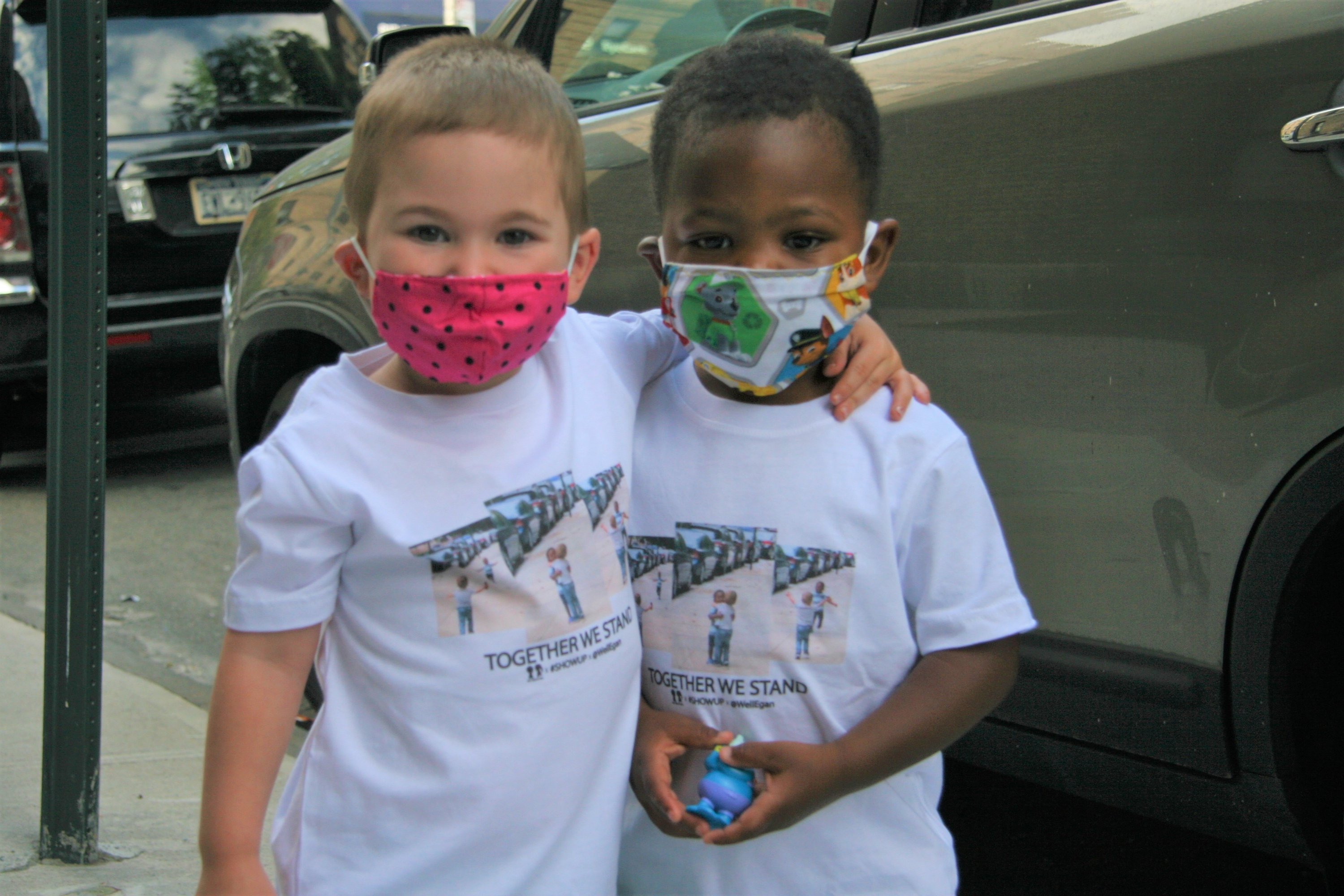 BOY MEETS GIRL® x #SHOWUP x @WellEgan White Kids T-Shirt featuring a simple yet impactful design promoting friendship and racial justice.