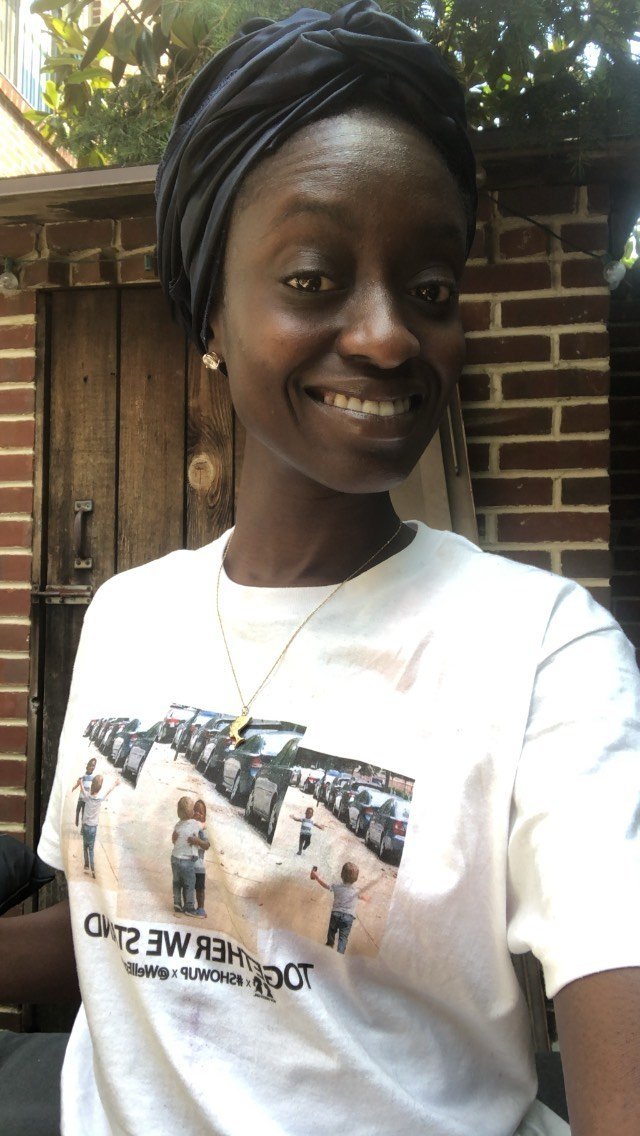 BOY MEETS GIRL® x #SHOWUP x @WellEgan White Unisex T-Shirt featuring a stylish design promoting friendship and racial justice.