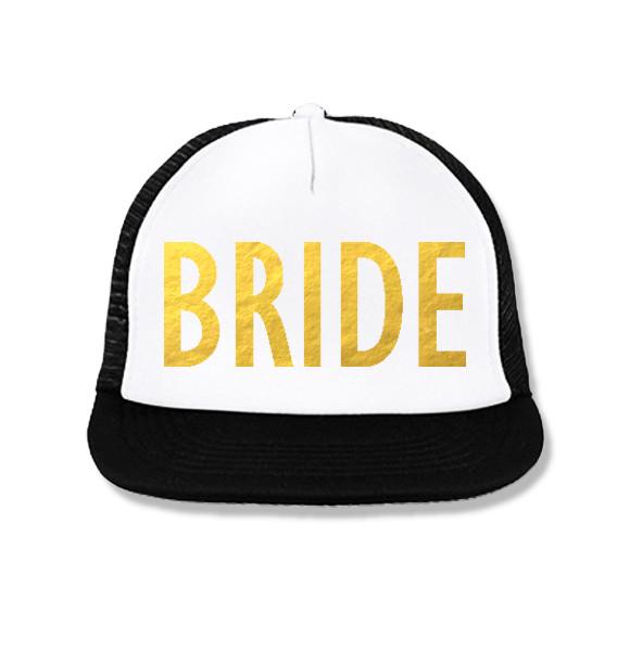 BRIDE Snapback Trucker Hat in white with gold foil print, featuring a structured high-profile design and plastic snapback closure.