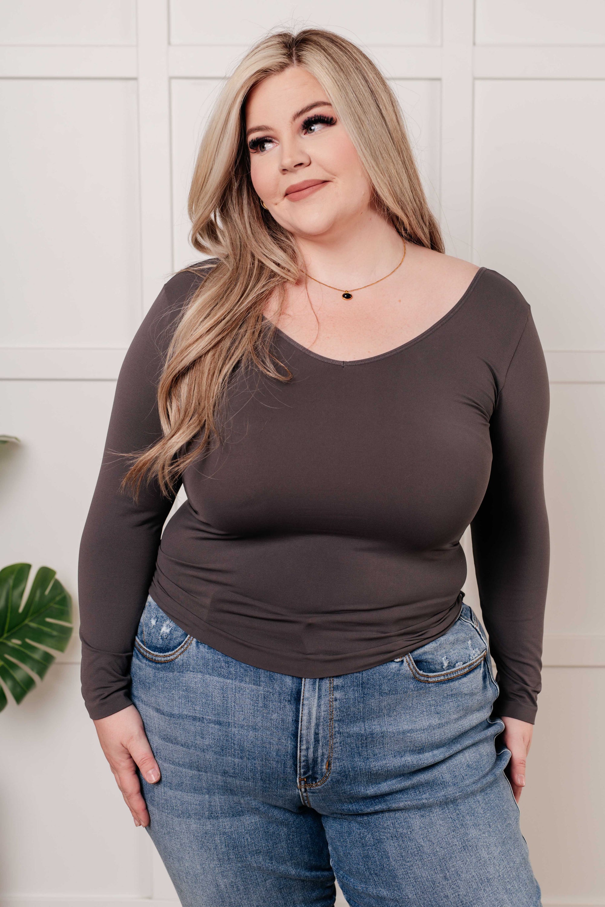 A seamless reversible V-neck top in charcoal, showcasing its soft brushed microfiber fabric and versatile scoop/V-neckline.