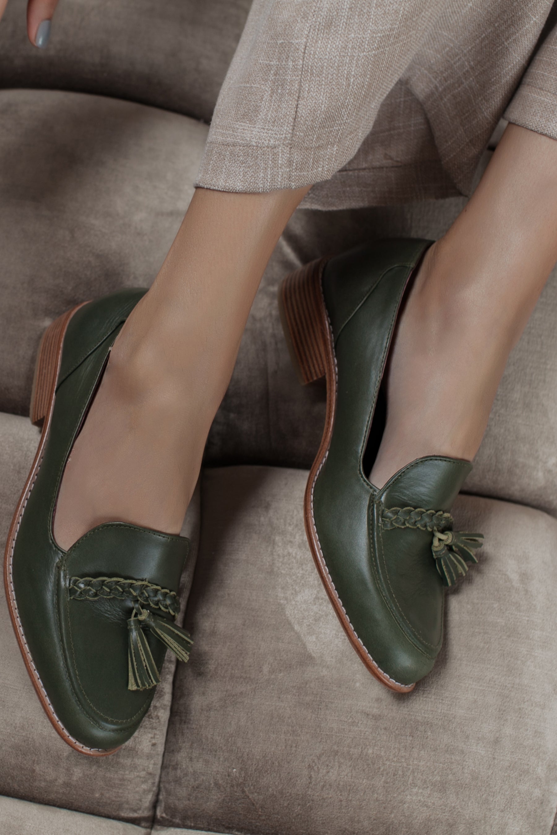 A pair of Brooklyn leather loafers featuring a smooth leather finish, braid and tassel details, and a low block heel, perfect for stylish comfort.
