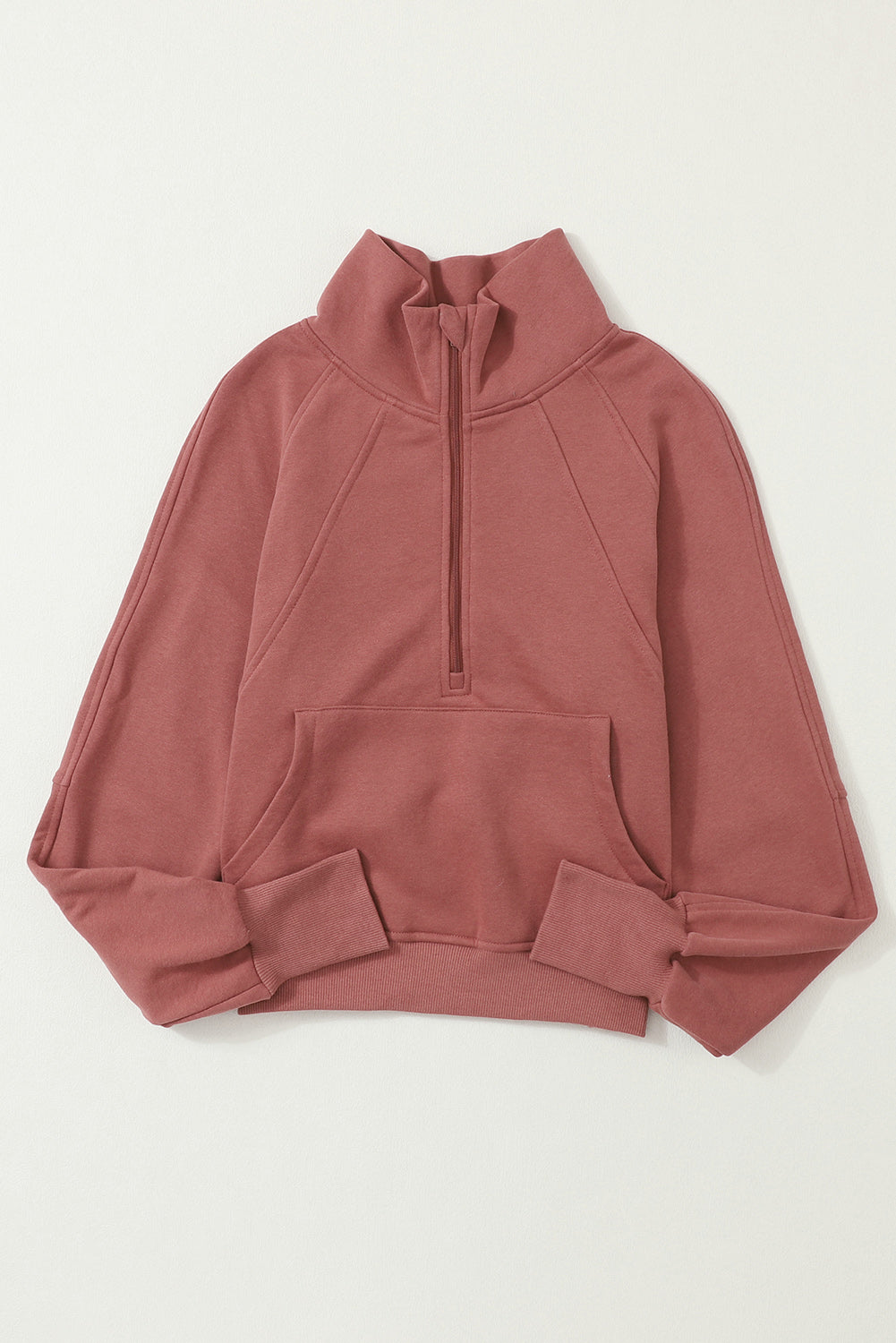Brown zip-up sweatshirt with stand collar and thumbhole sleeves, featuring a textured design and kangaroo pocket.