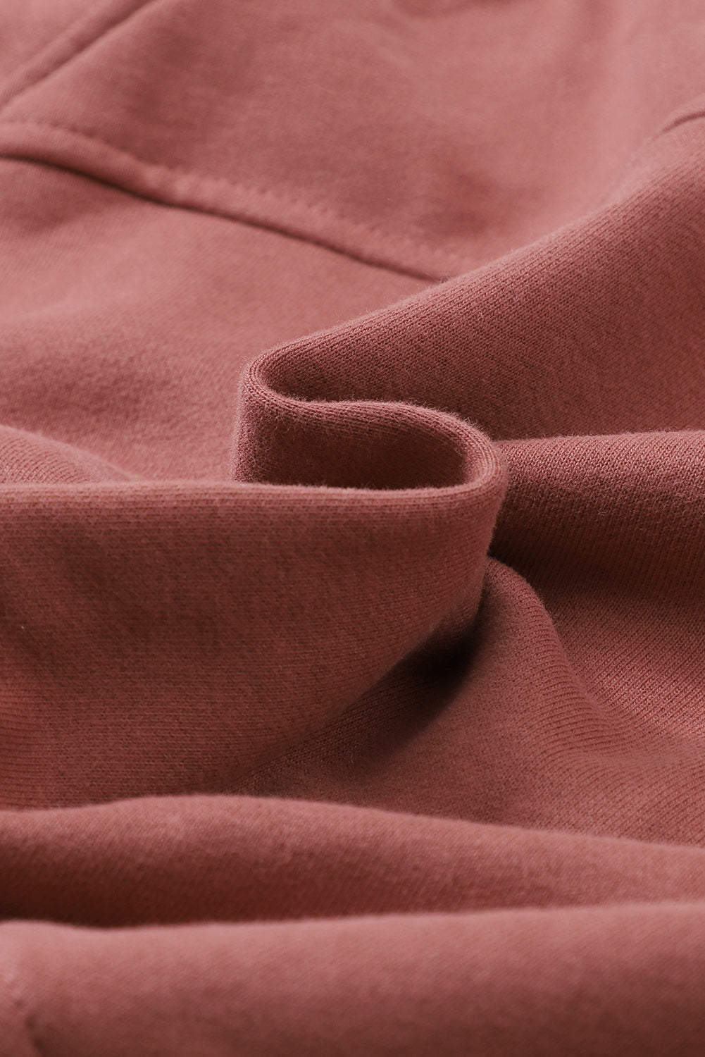 Brown zip-up sweatshirt with stand collar and thumbhole sleeves, featuring a textured design and kangaroo pocket.