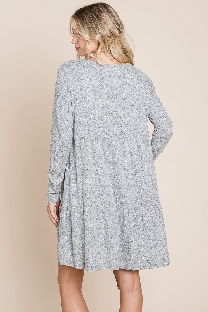 Brushed Hacci Tiered Pleated Mini Dress featuring long sleeves, a round neck, and a knee-length ruffled hem, perfect for various occasions.