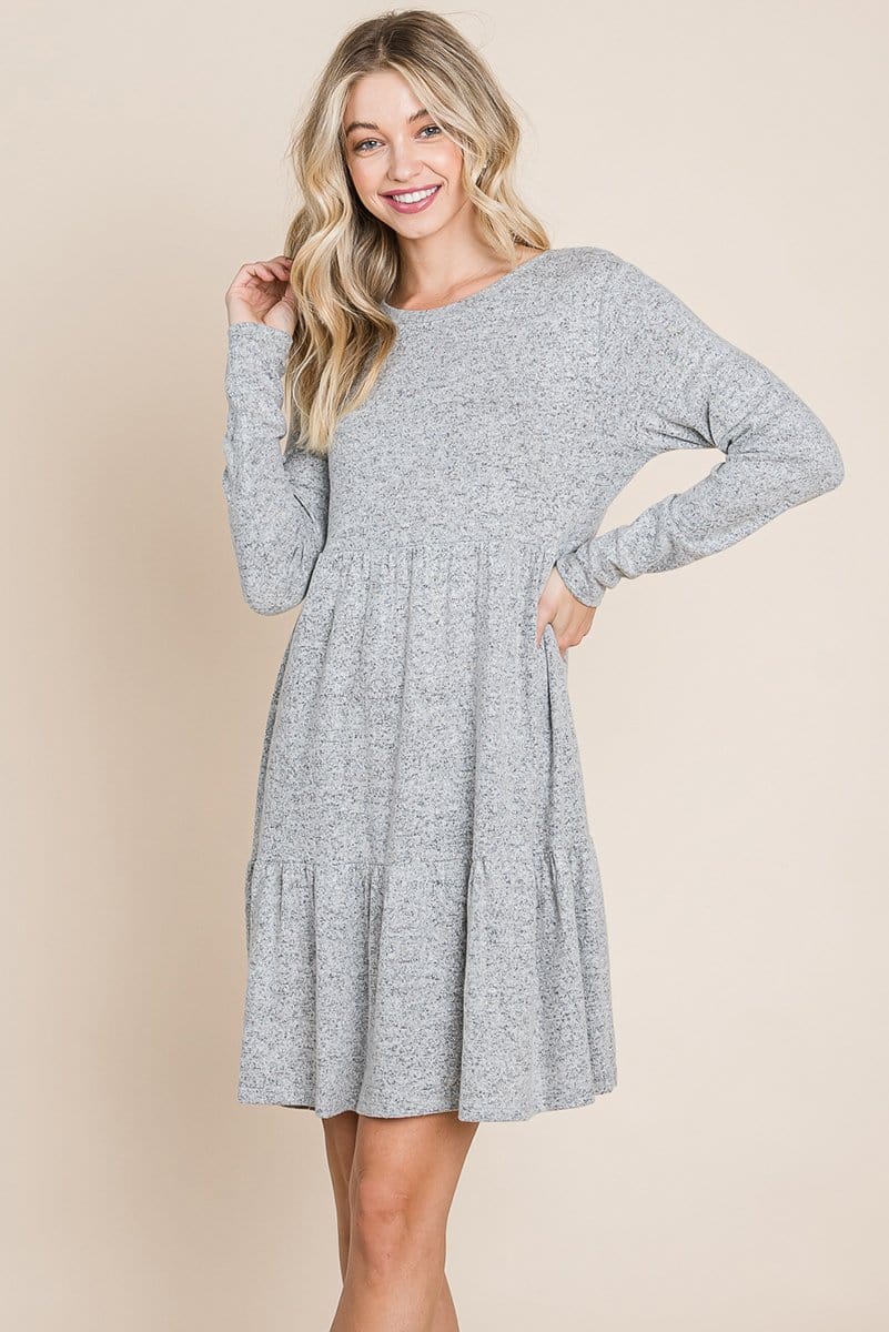 Brushed Hacci Tiered Pleated Mini Dress featuring long sleeves, a round neck, and a knee-length ruffled hem, perfect for various occasions.