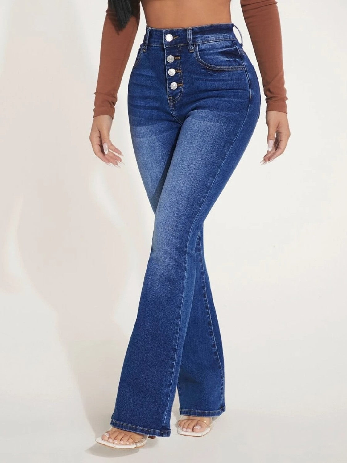 A pair of stylish button fly bootcut jeans with pockets, showcasing a moderate stretch fabric and a classic design suitable for various occasions.
