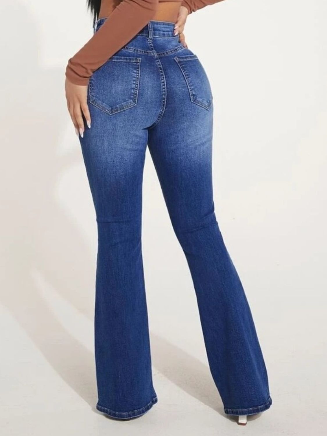 A pair of stylish button fly bootcut jeans with pockets, showcasing a moderate stretch fabric and a classic design suitable for various occasions.