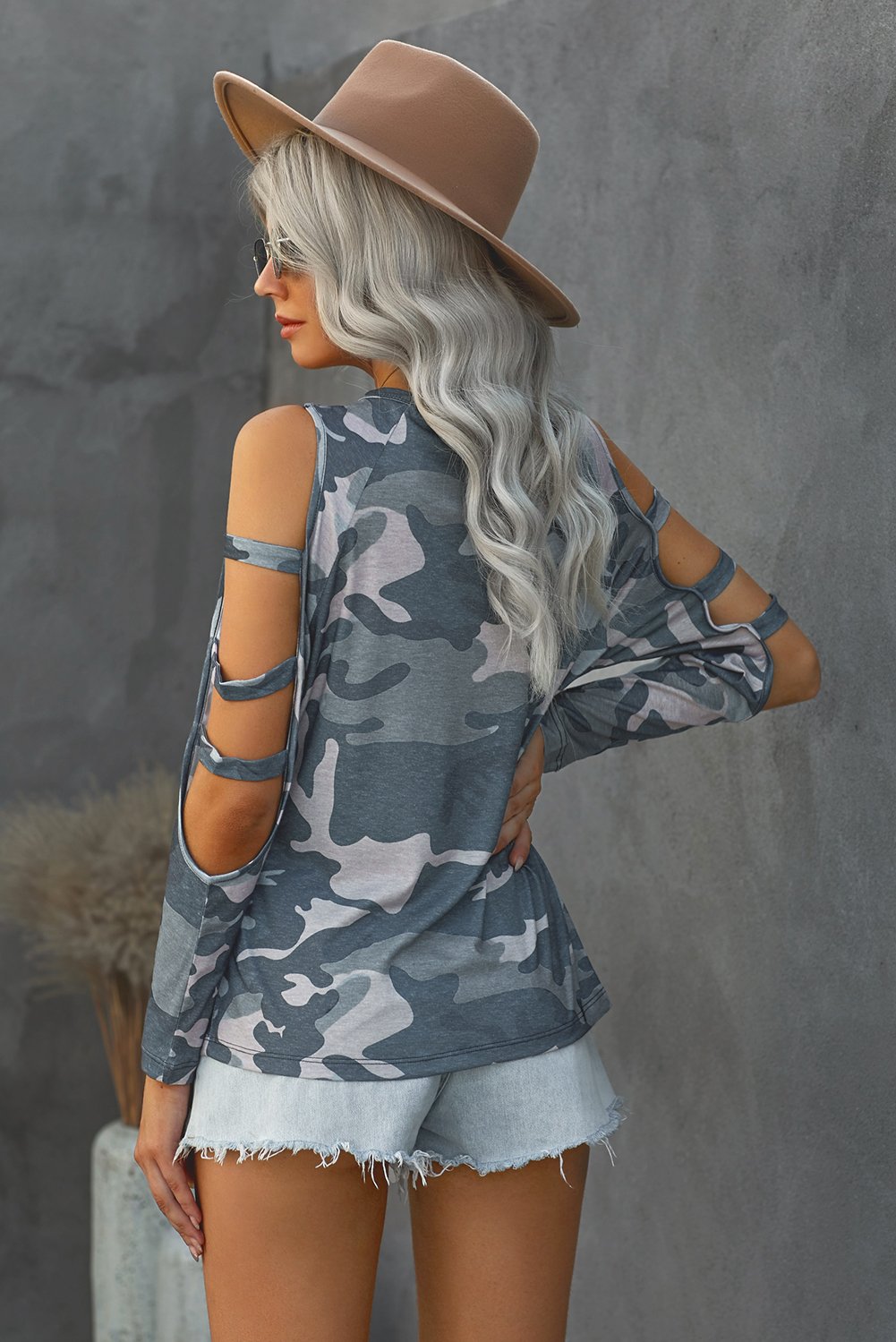 A stylish camouflage long sleeve top featuring hollow-out shoulders, perfect for casual wear.