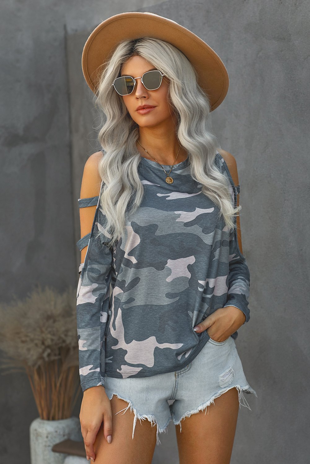 A stylish camouflage long sleeve top featuring hollow-out shoulders, perfect for casual wear.