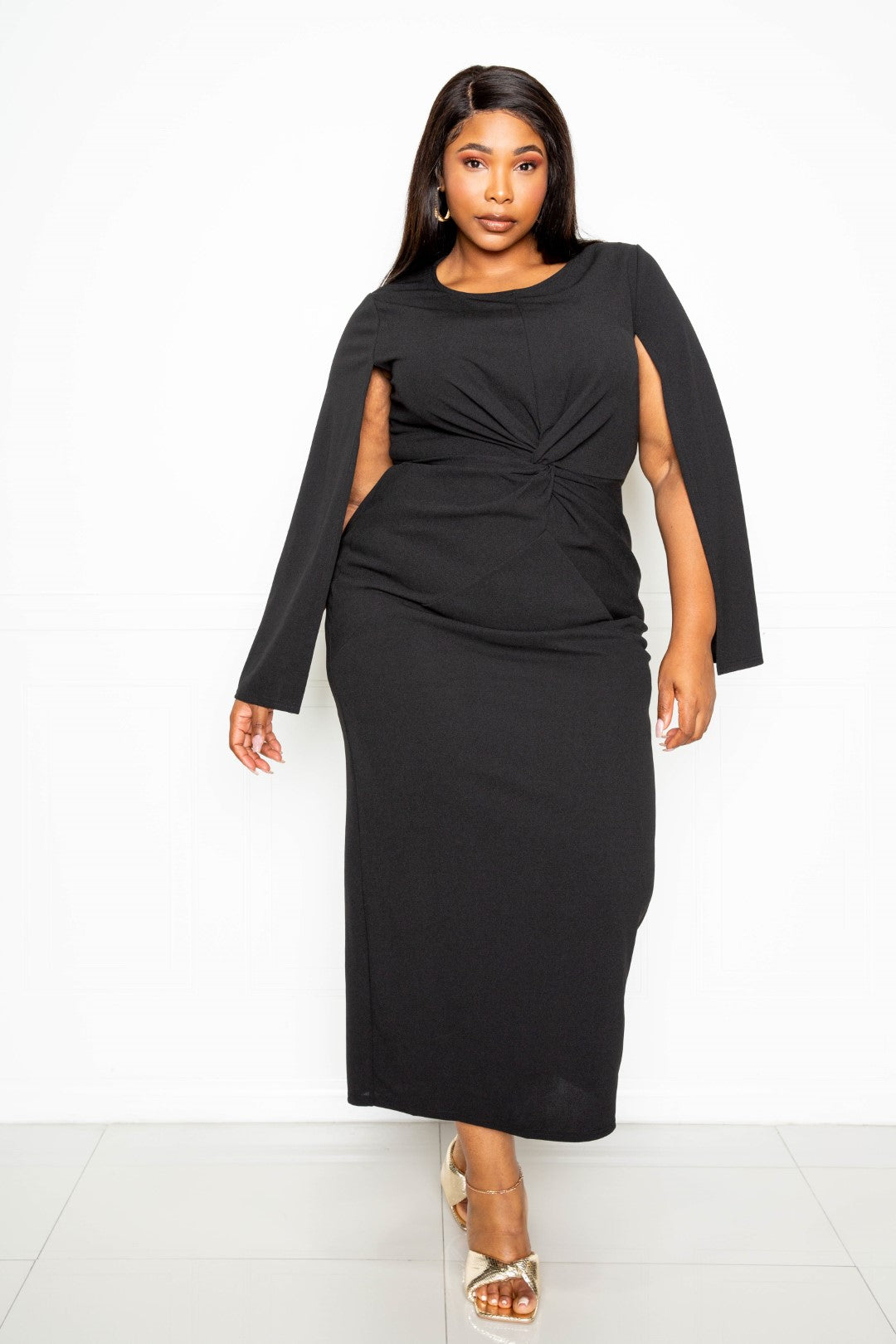 A stylish black cape sleeve dress featuring a knot detail at the waist, designed for plus sizes.