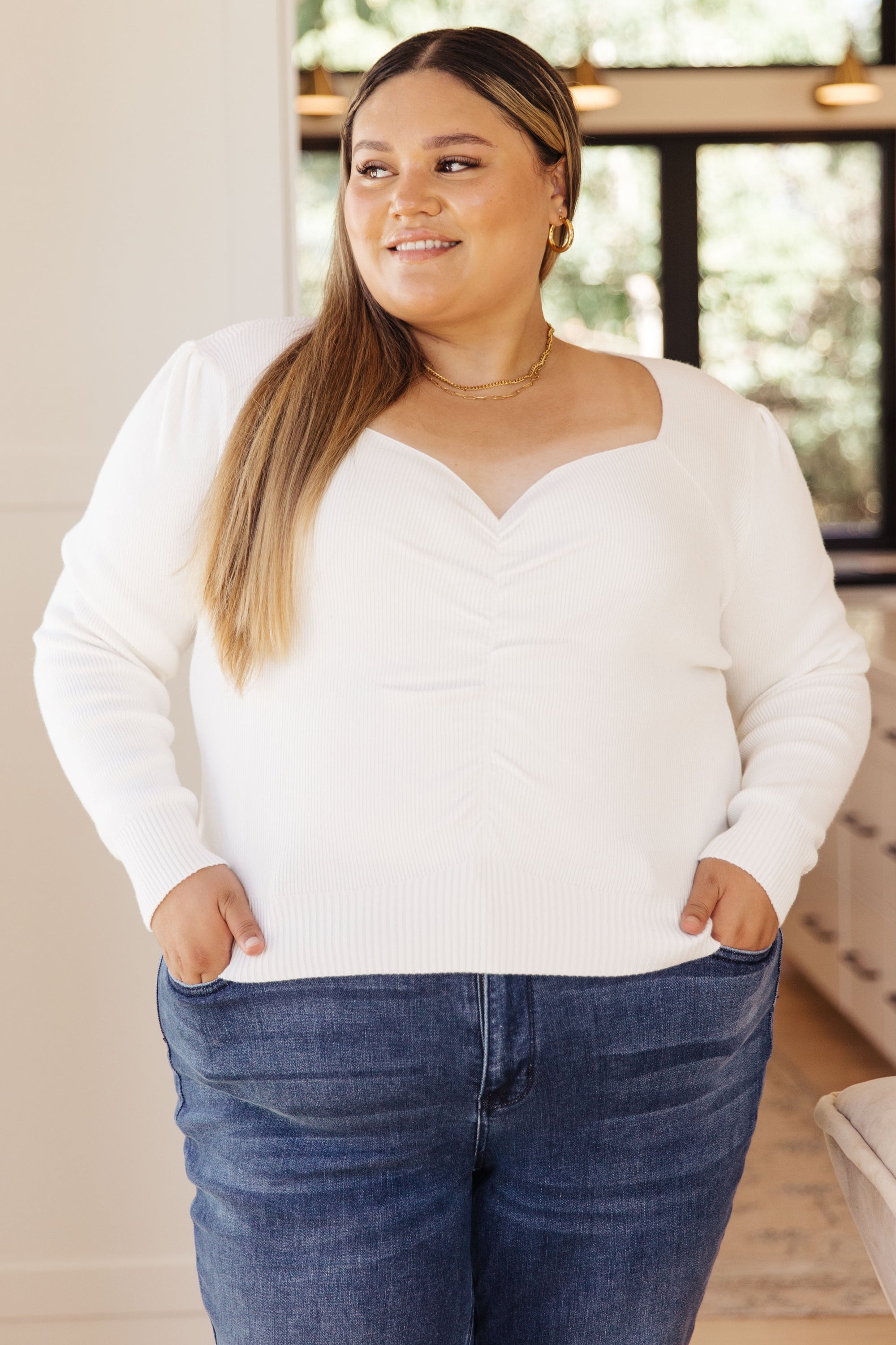 A stylish long sleeve top featuring a sweetheart neckline and puff sleeves, made from lightweight ribbed knit fabric.