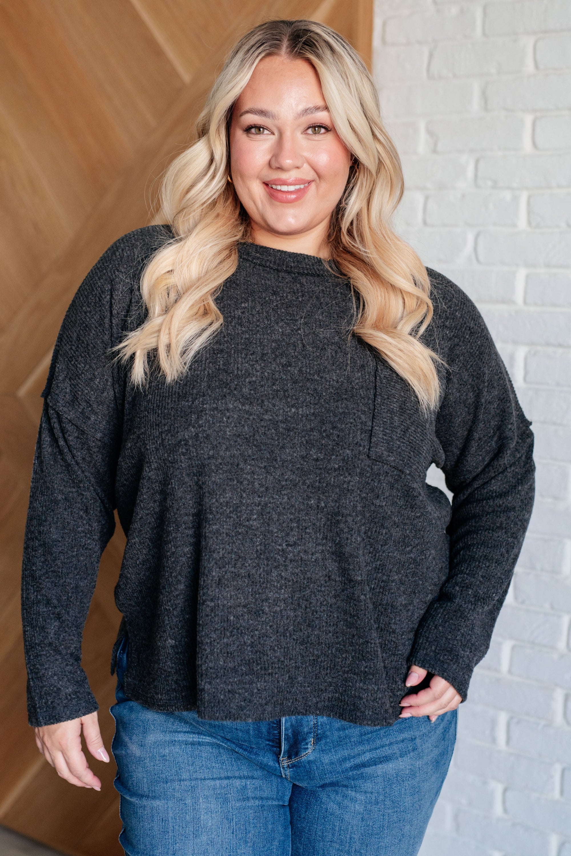 Casual Tuesday Ribbed Knit Sweater in Black featuring a banded round neckline, drop shoulder design, and functional patch pockets.
